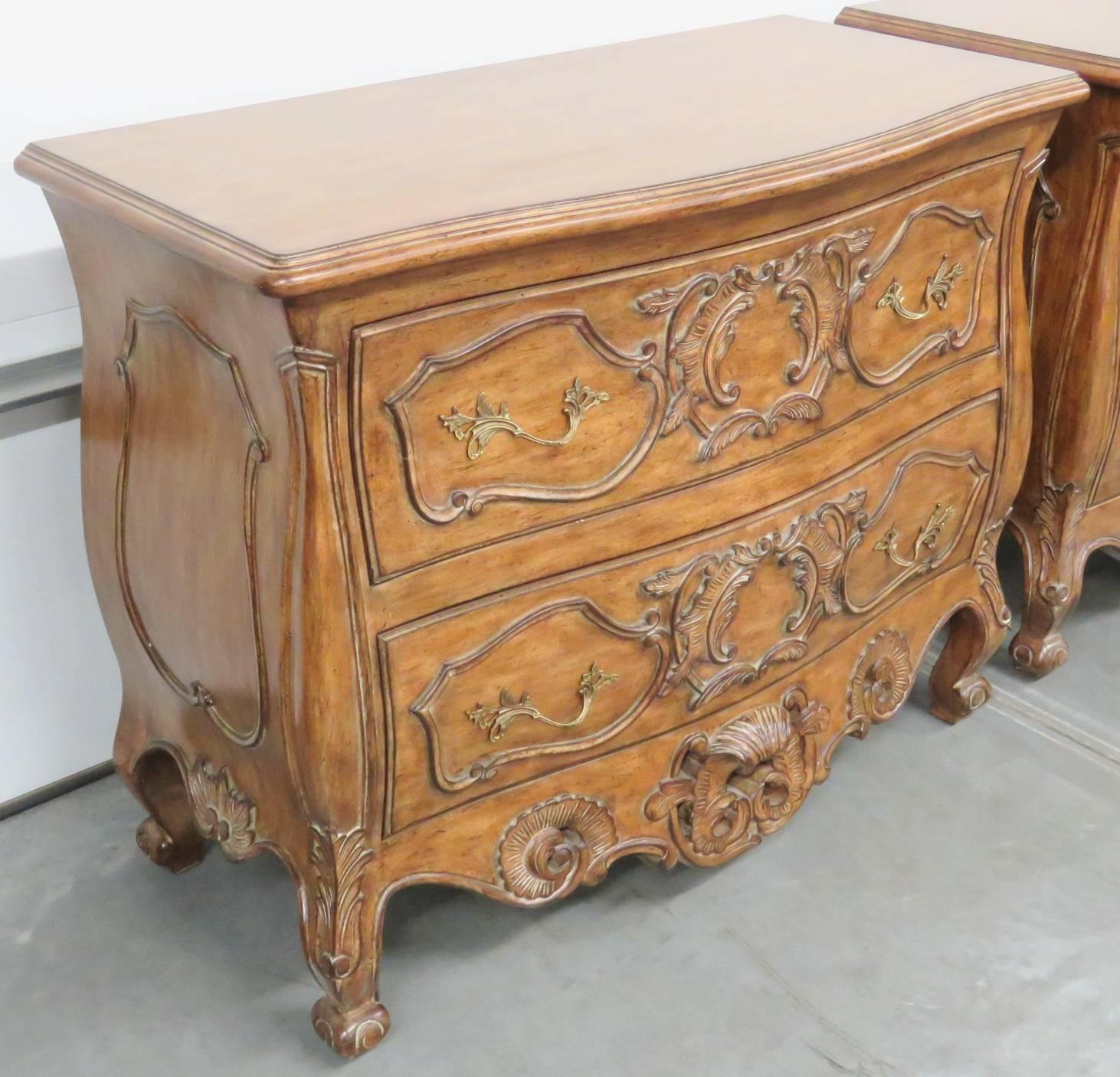 Pair of French style carved walnut commodes.