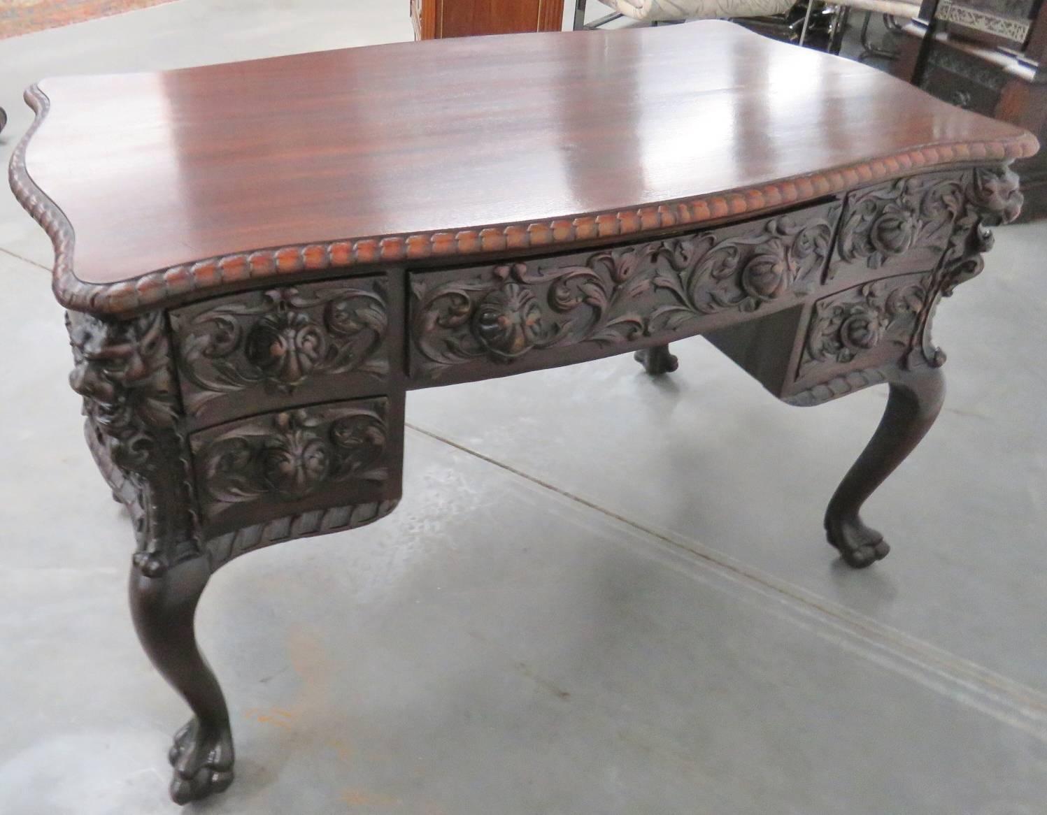 Carved mahogany with griffins and ball and claw feet.