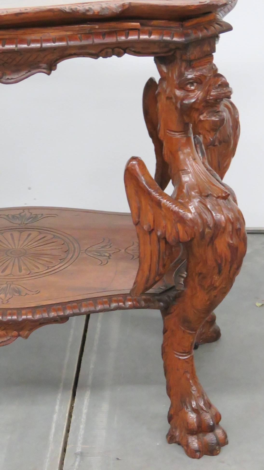 Carved walnut griffins. Glass top tray table.