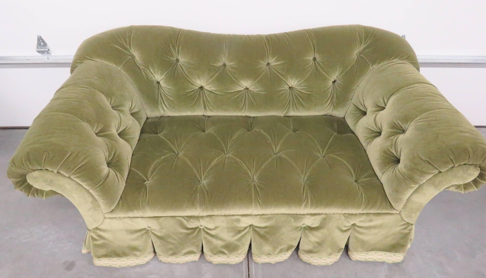 Green tufted velvet upholstery.
