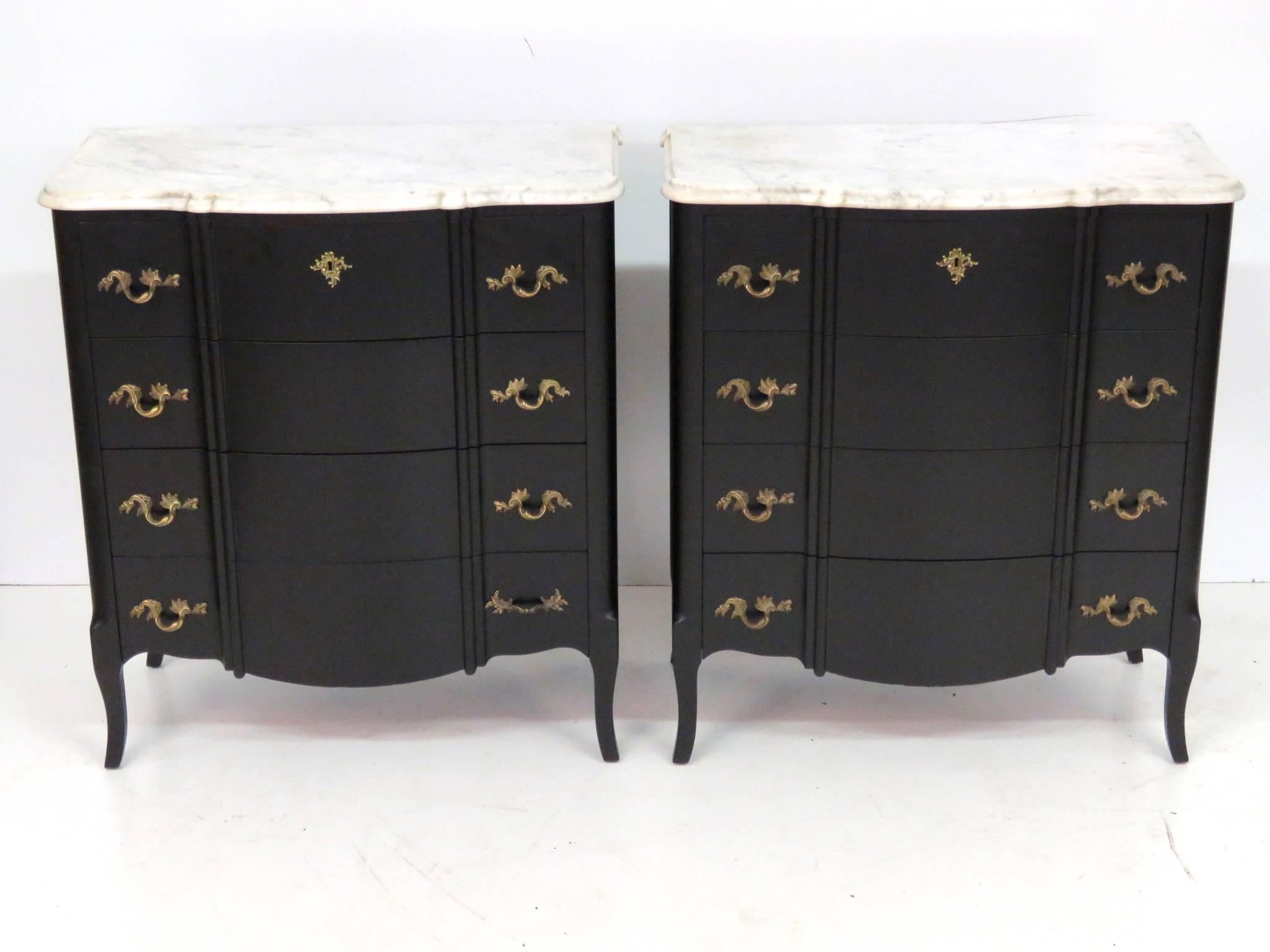 Marble-top commodes with ebonized frame.