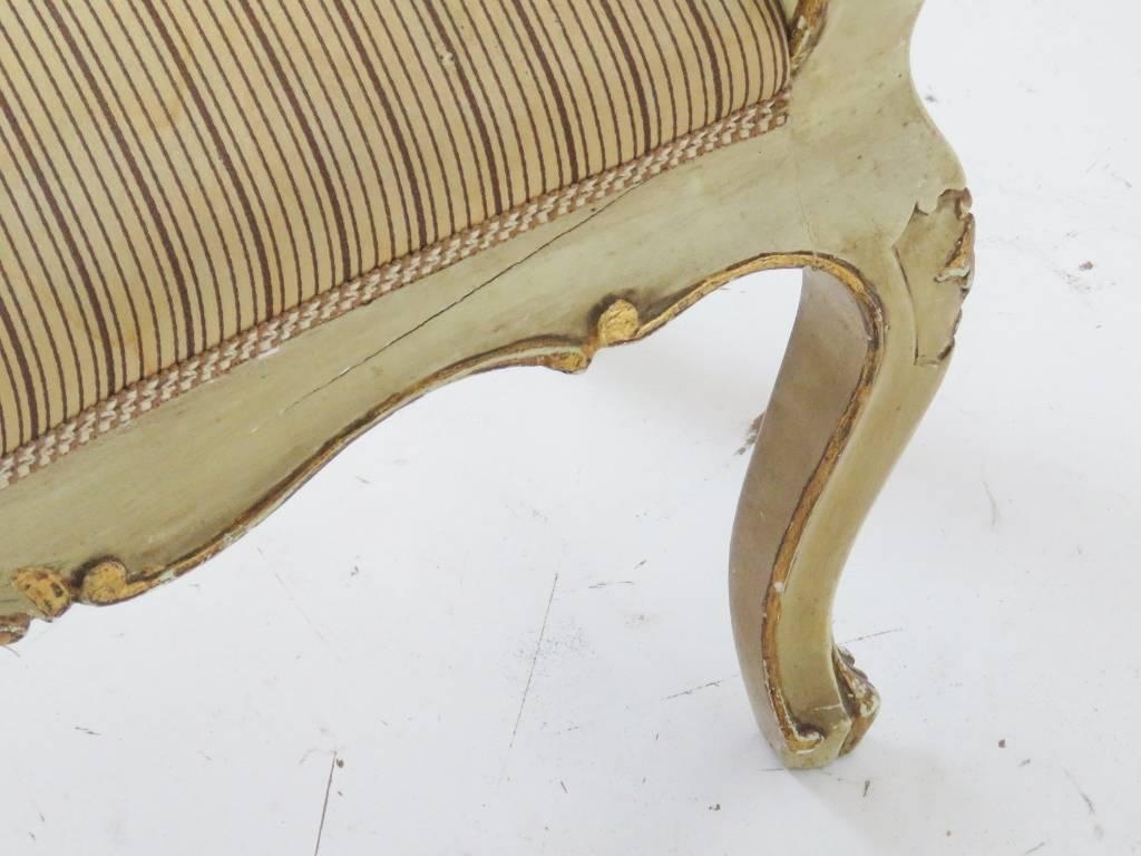 Cream painted frame with floral paint decoration and gilt highlights. Striped upholstered seat.