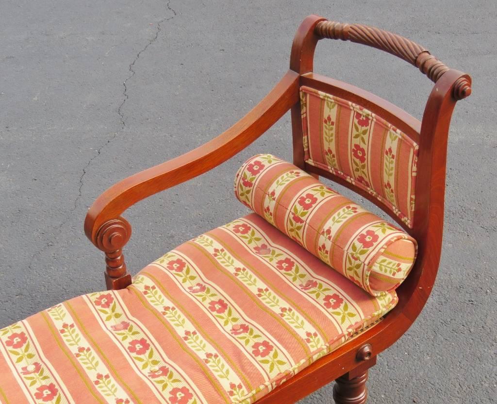 Carved frame with brass feet. Caned seat with floral cushion and back.