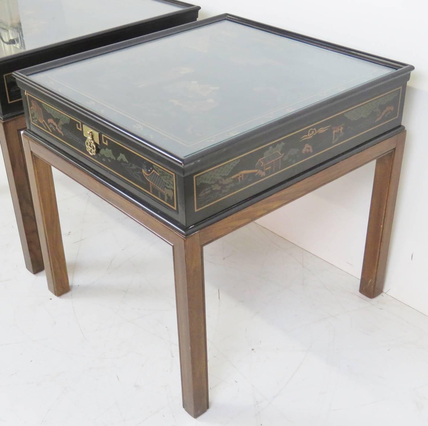 Black lacquered finish with chinoiserie paint decoration and glass tops.