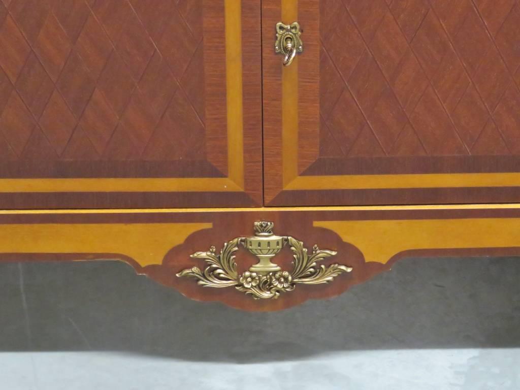 Parquetry inlaid with brass mounts and hardware. Marble top.