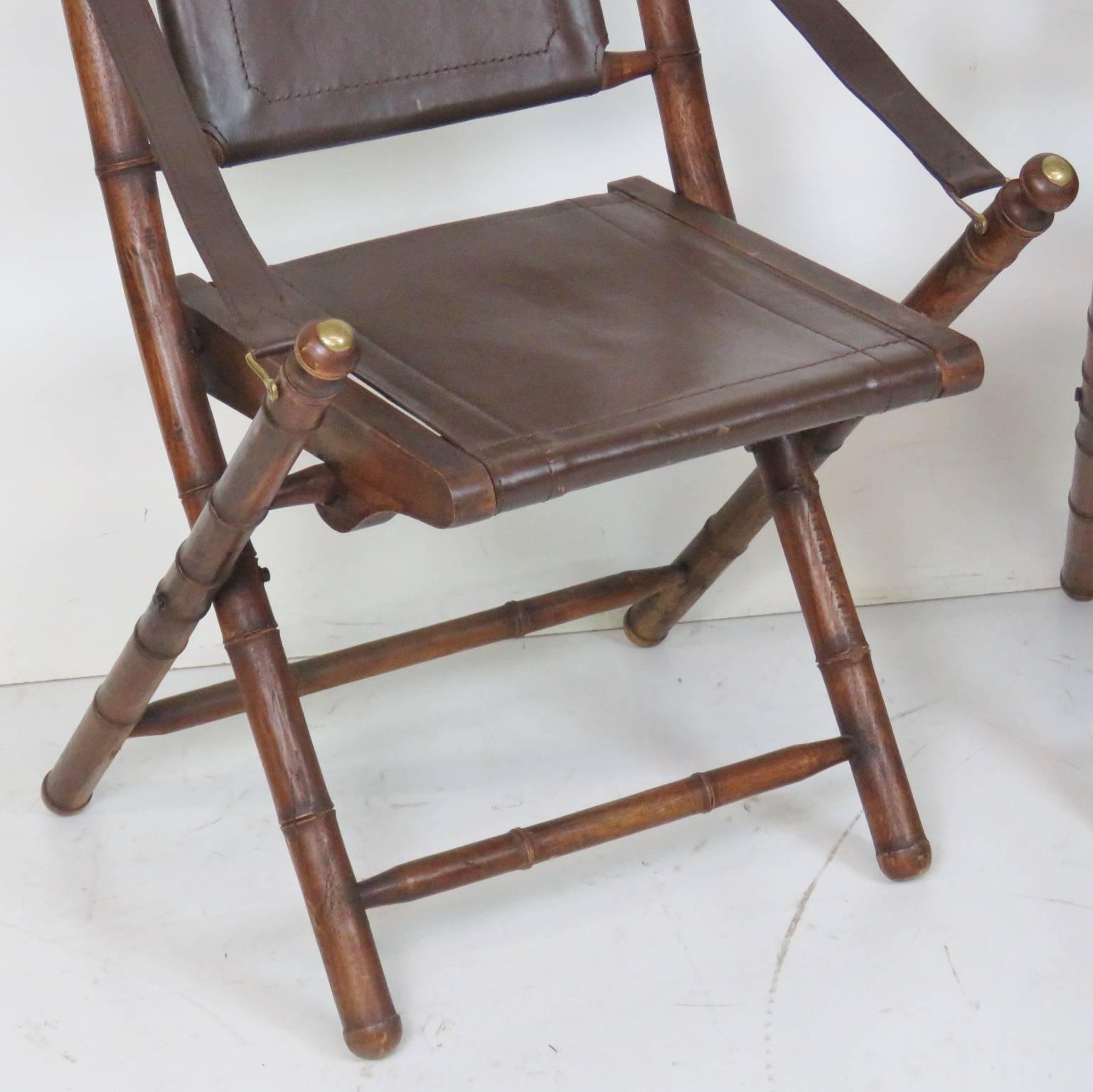 Faux bamboo frame with brown leather back and seat.