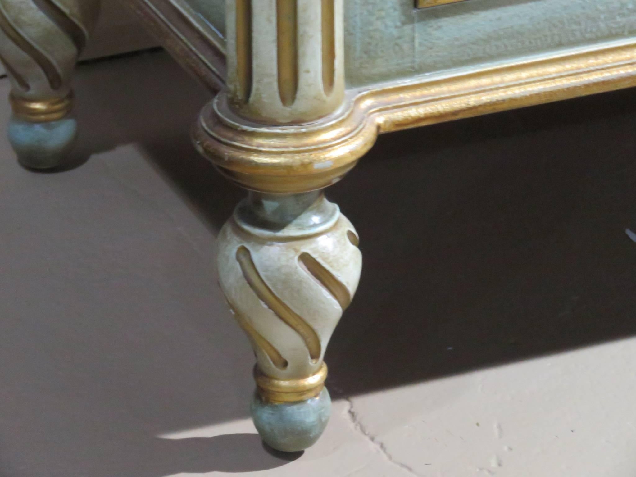 Distressed cream and turquoise painted frame with gilt highlights. Carved sides and drawers. Faux marble top painted.