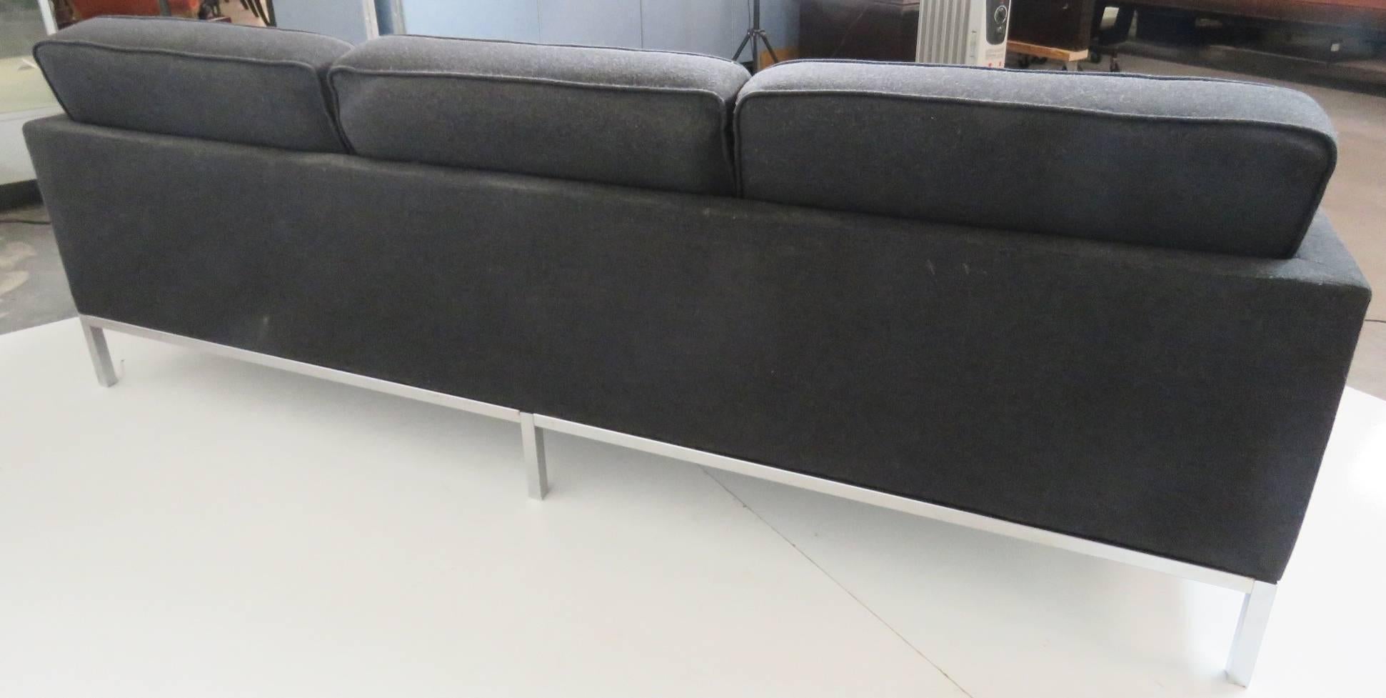 Milo Baughman style sofa. Tufted grey upholstered with chrome frame.