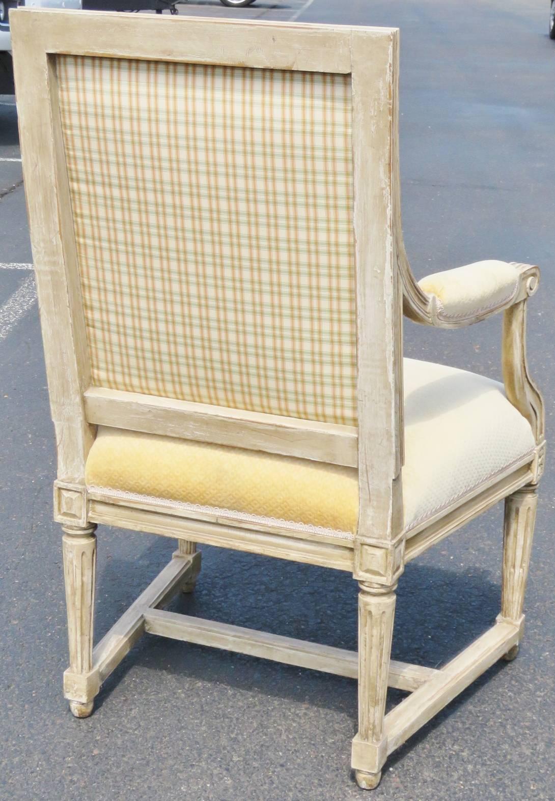 Distressed painted carved frame. Yellow upholstered back and seat. Seat back upholstered with complimenting stripes.