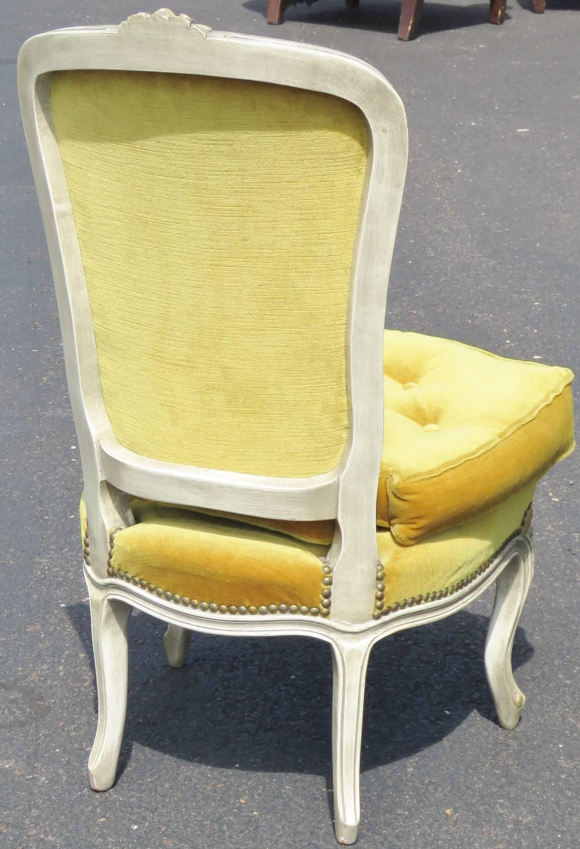 Carved cream frames. Yellow tufted upholstery.