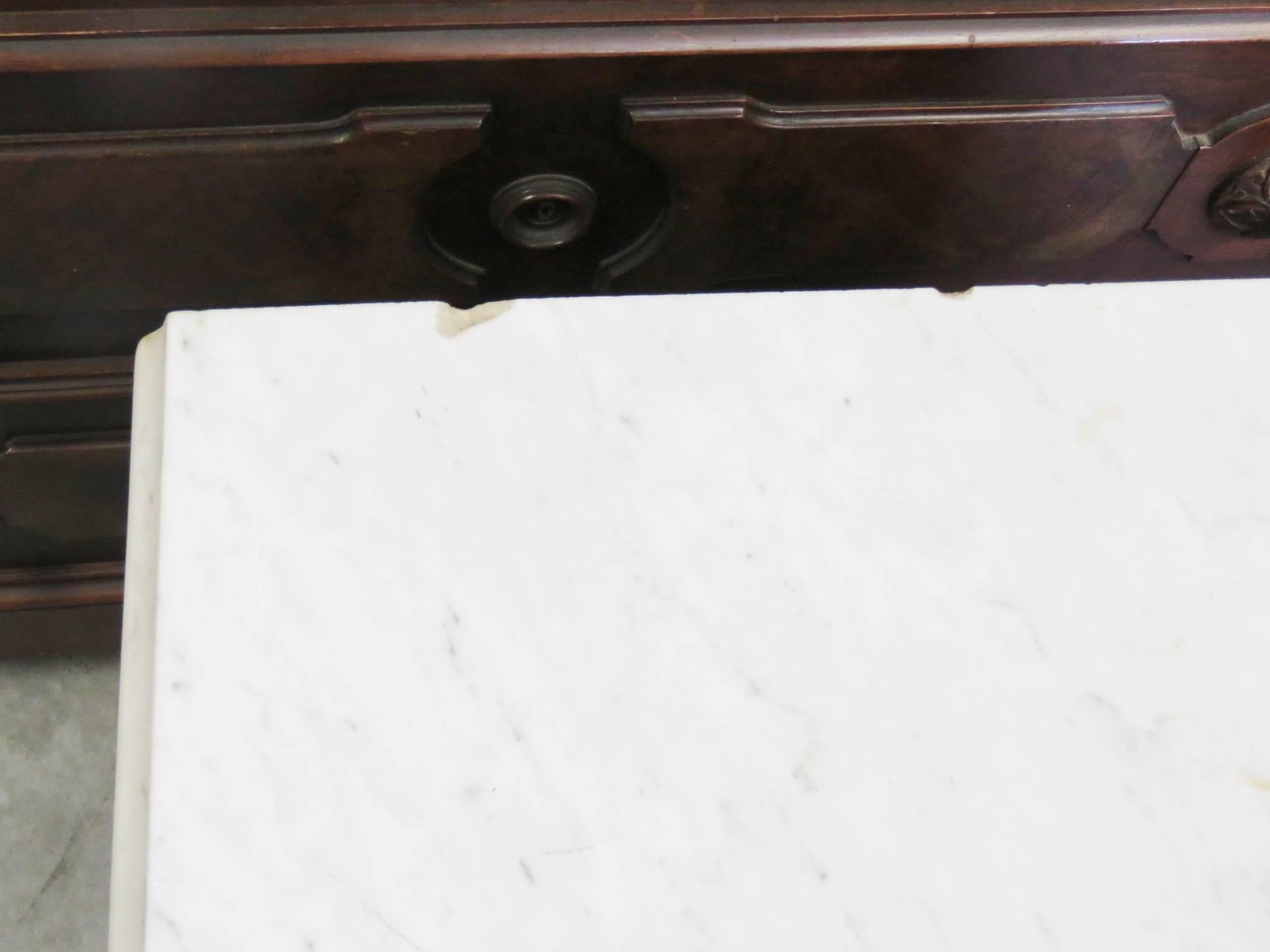 Carved walnut with burl walnut panels. Marble top. Set includes bed, nightstand and chest with mirror.
