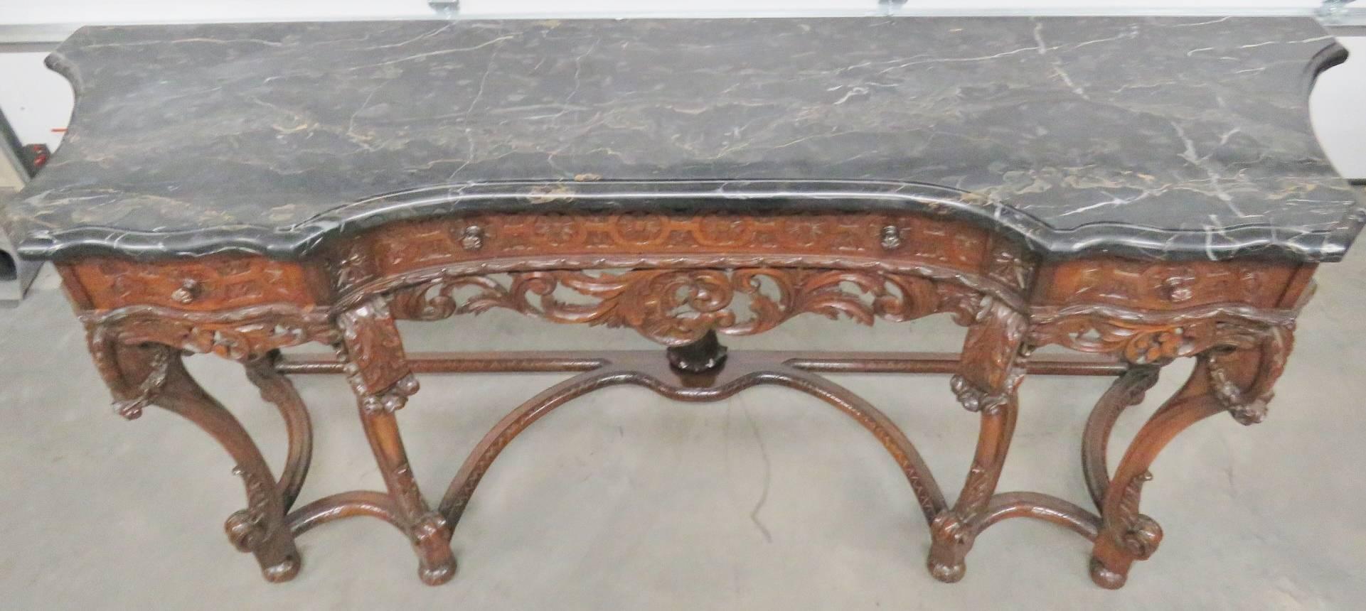 Heavily carved base. Marble top.