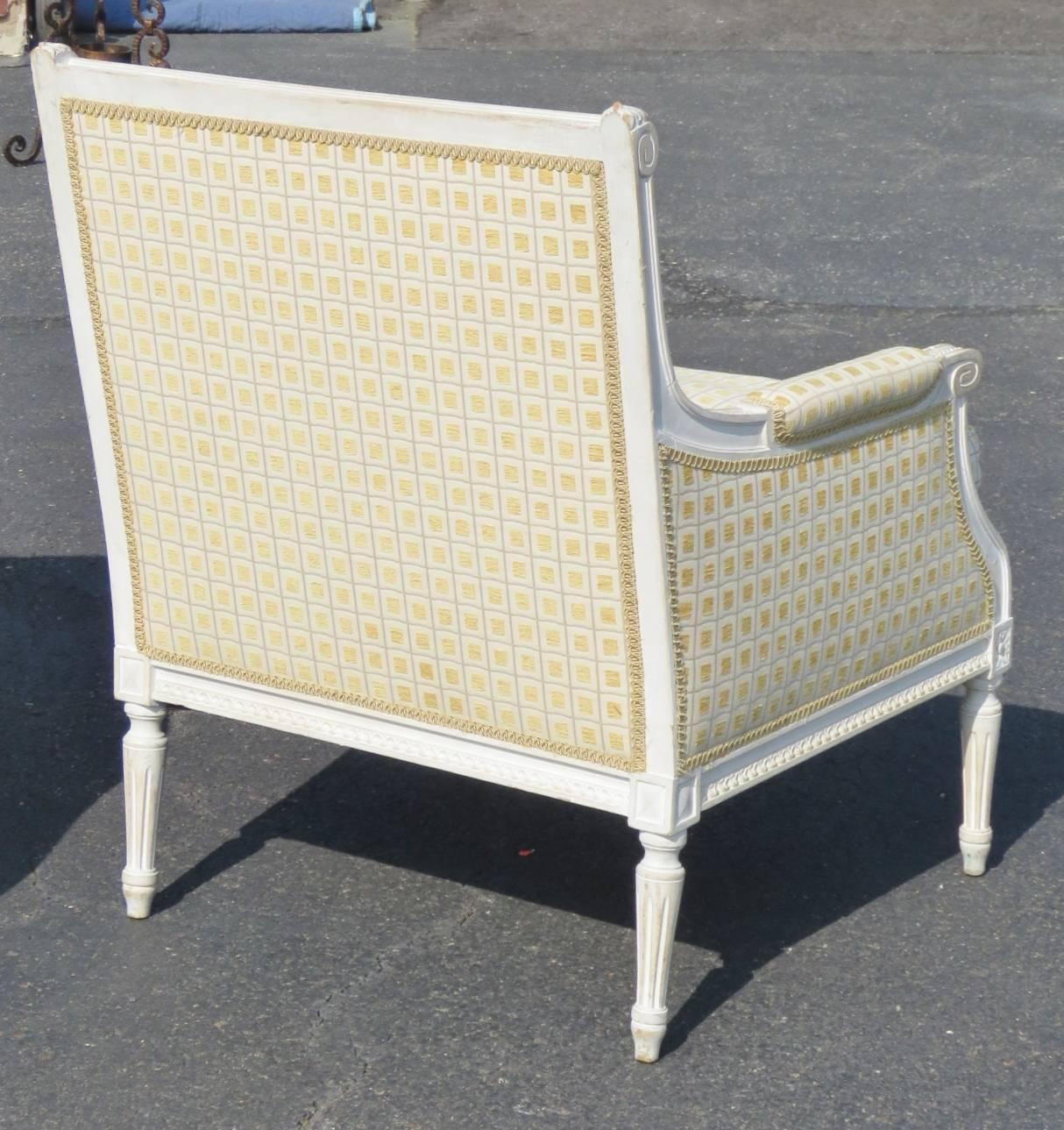 Distressed cream painted carved frames. Yellow checkered upholstery.