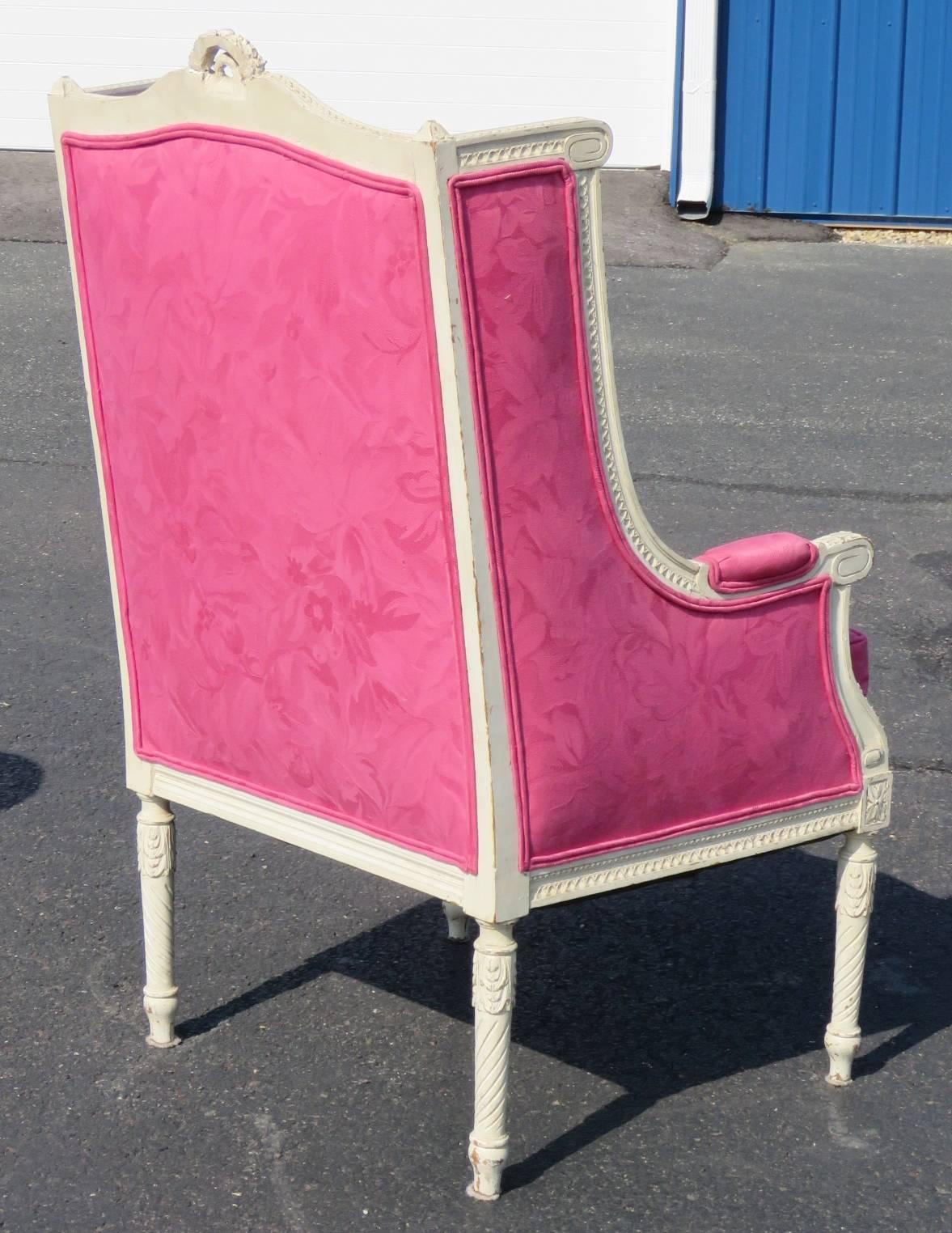Distressed cream painted carved frame. Pink floral upholstery.