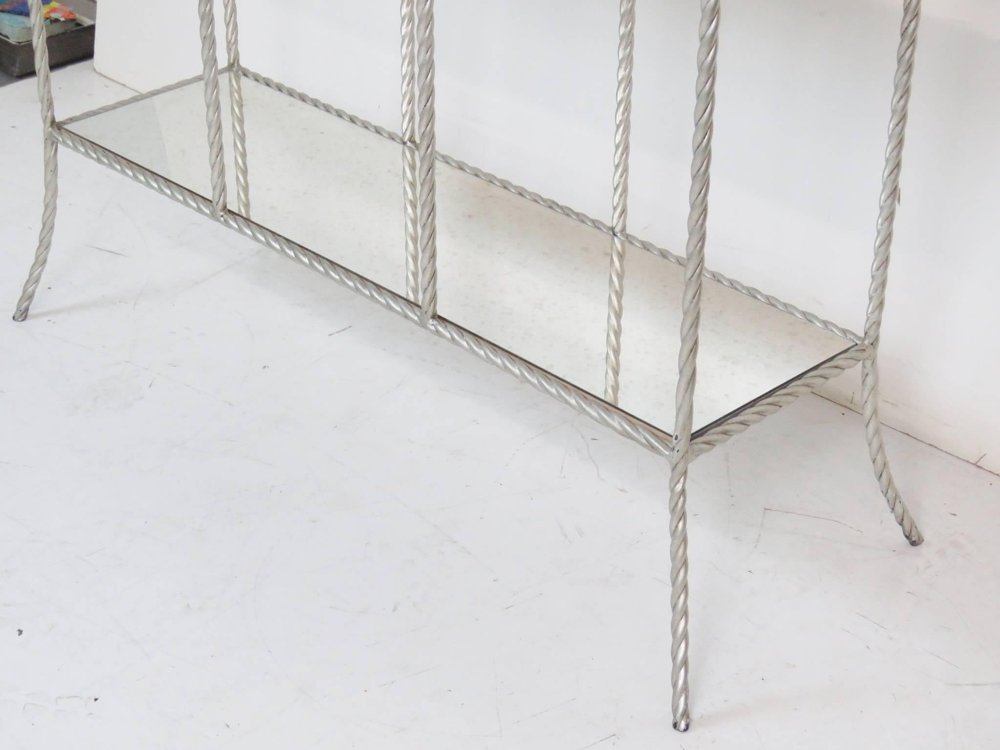 Silver gilt painted metal rope twist frame. Églomiséd mirrored shelves.