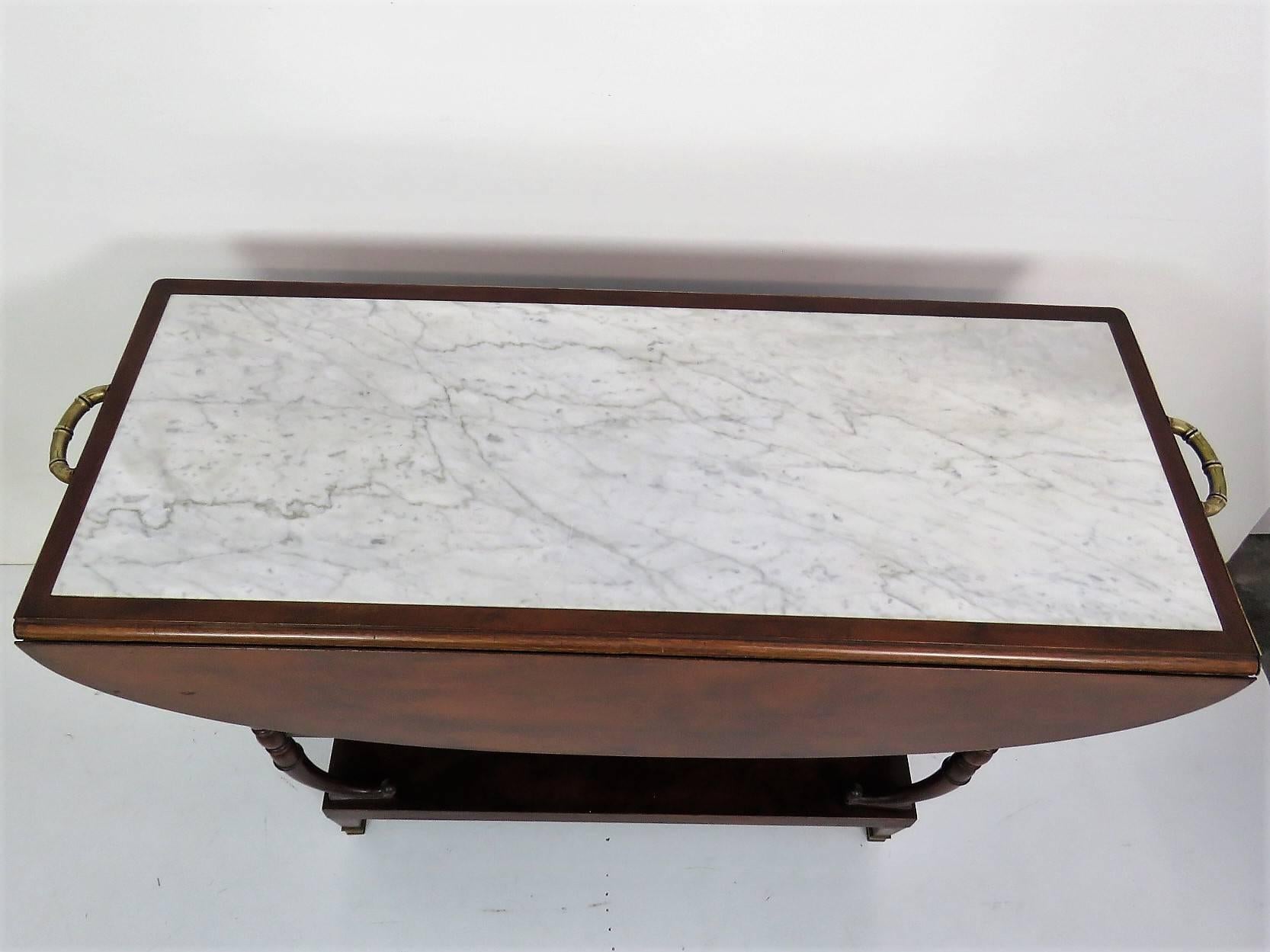 Marble-top. Drop front. Mahogany carved frame.