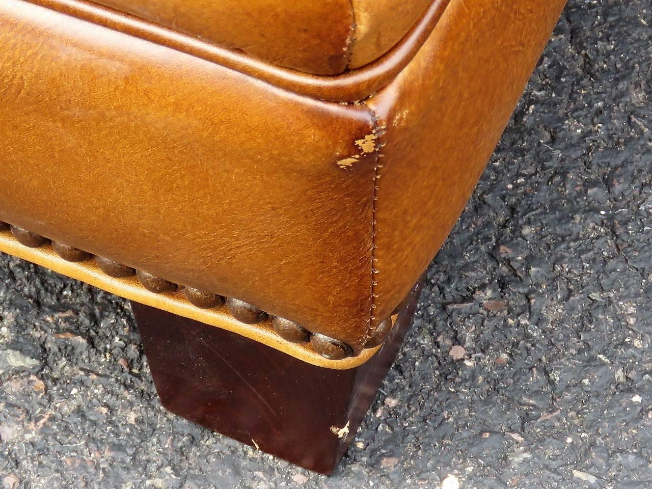 Distressed brown leather with tacked frame.