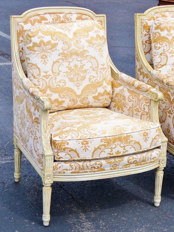 Pair of Distressed Cream Painted Carved Bergeres For Sale at 1stDibs