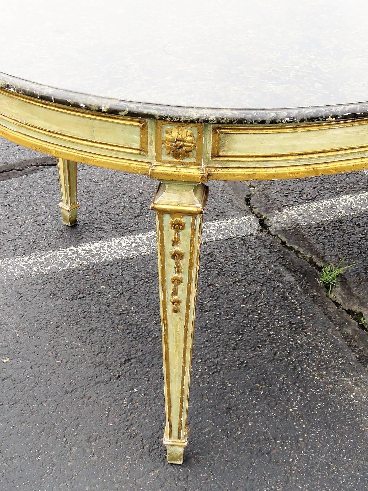 Faux painted marble top. Distressed cream painted frame with gilt highlights. Two 24