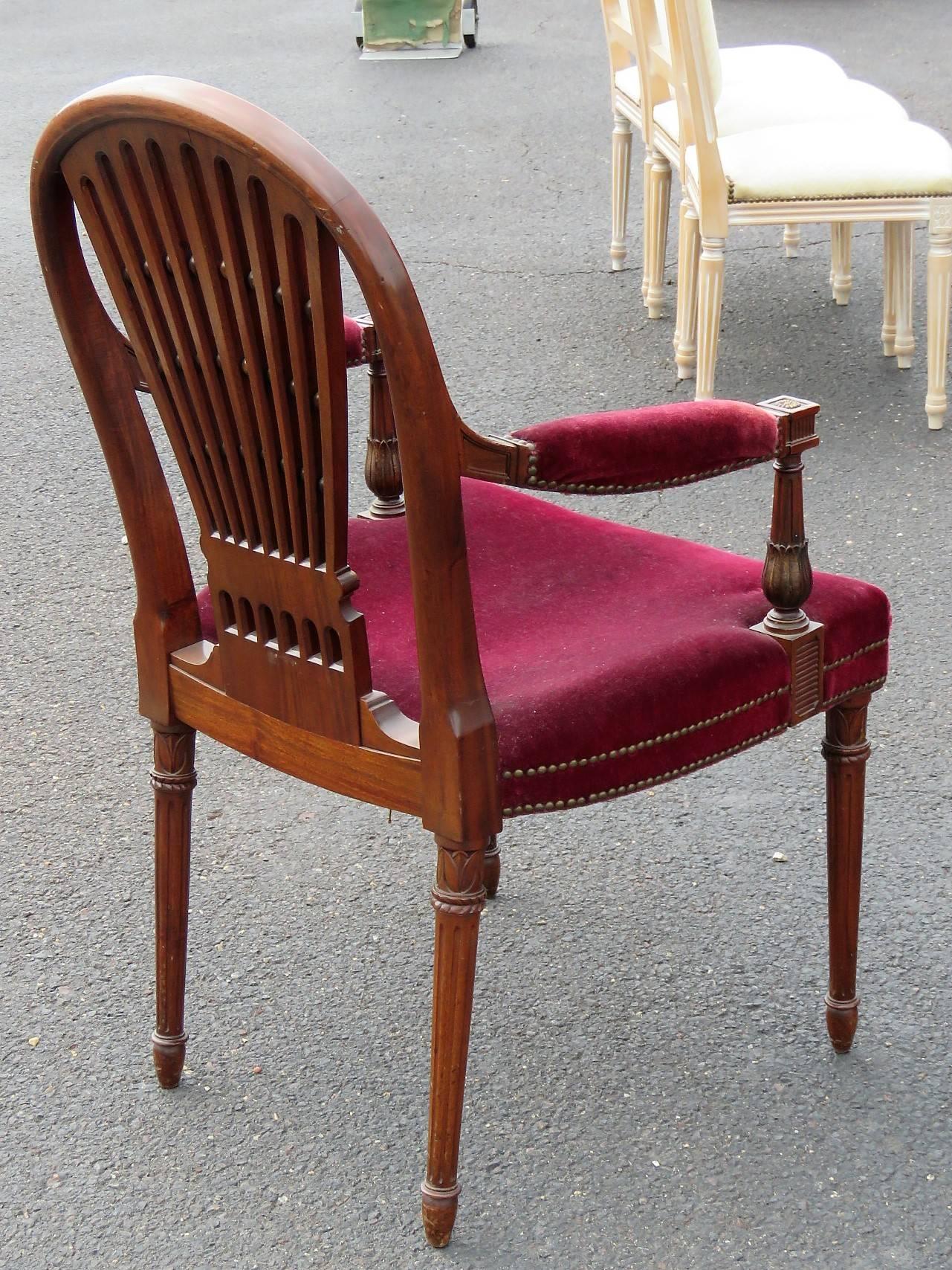 12 Jansen Directoire style walnut carved frame chairs. Red upholstered seats.