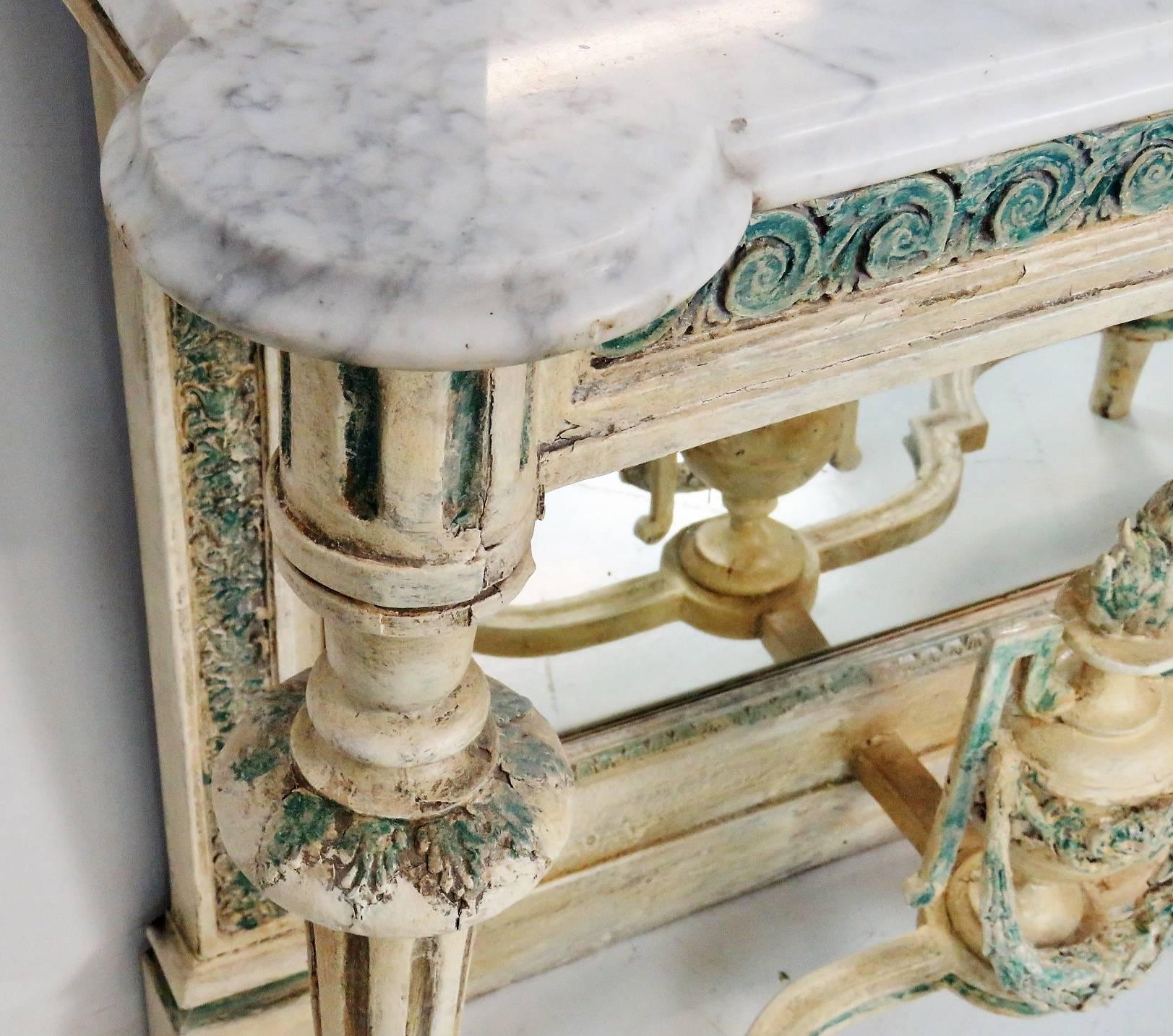 Distressed cream painted frame with turquoise highlights. Mirrored back. Marble-top.