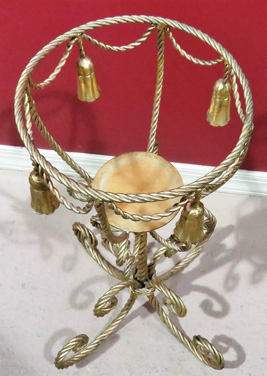 Gilt painted metal rope twist frame with tassels.