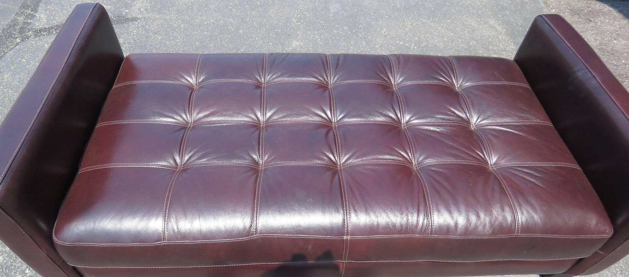 Brown tufted leather daybed. Wood legs. 