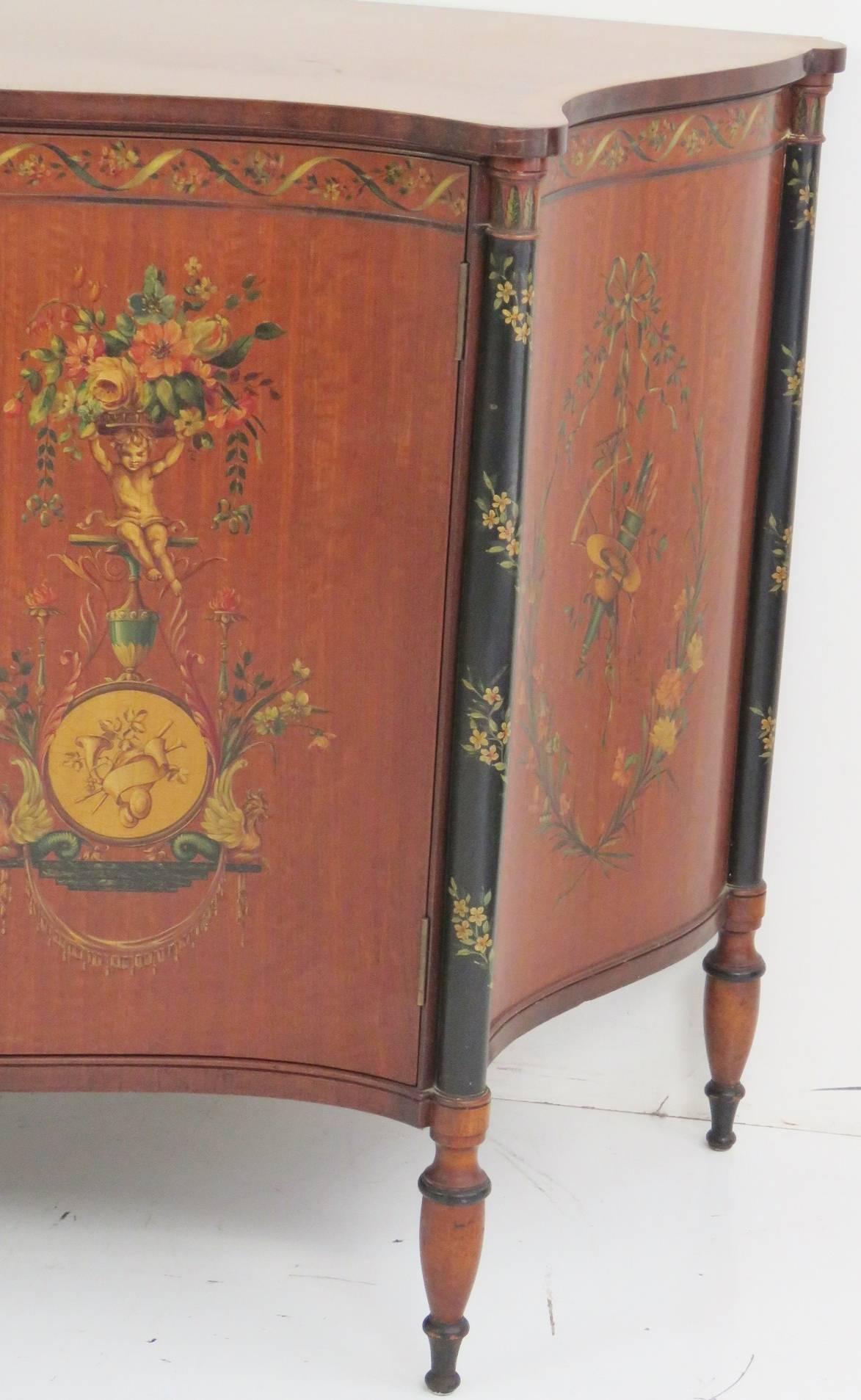 Floral paint decoration with puttis and musical instruments. Ebonized highlights. Drawers on the inside.
