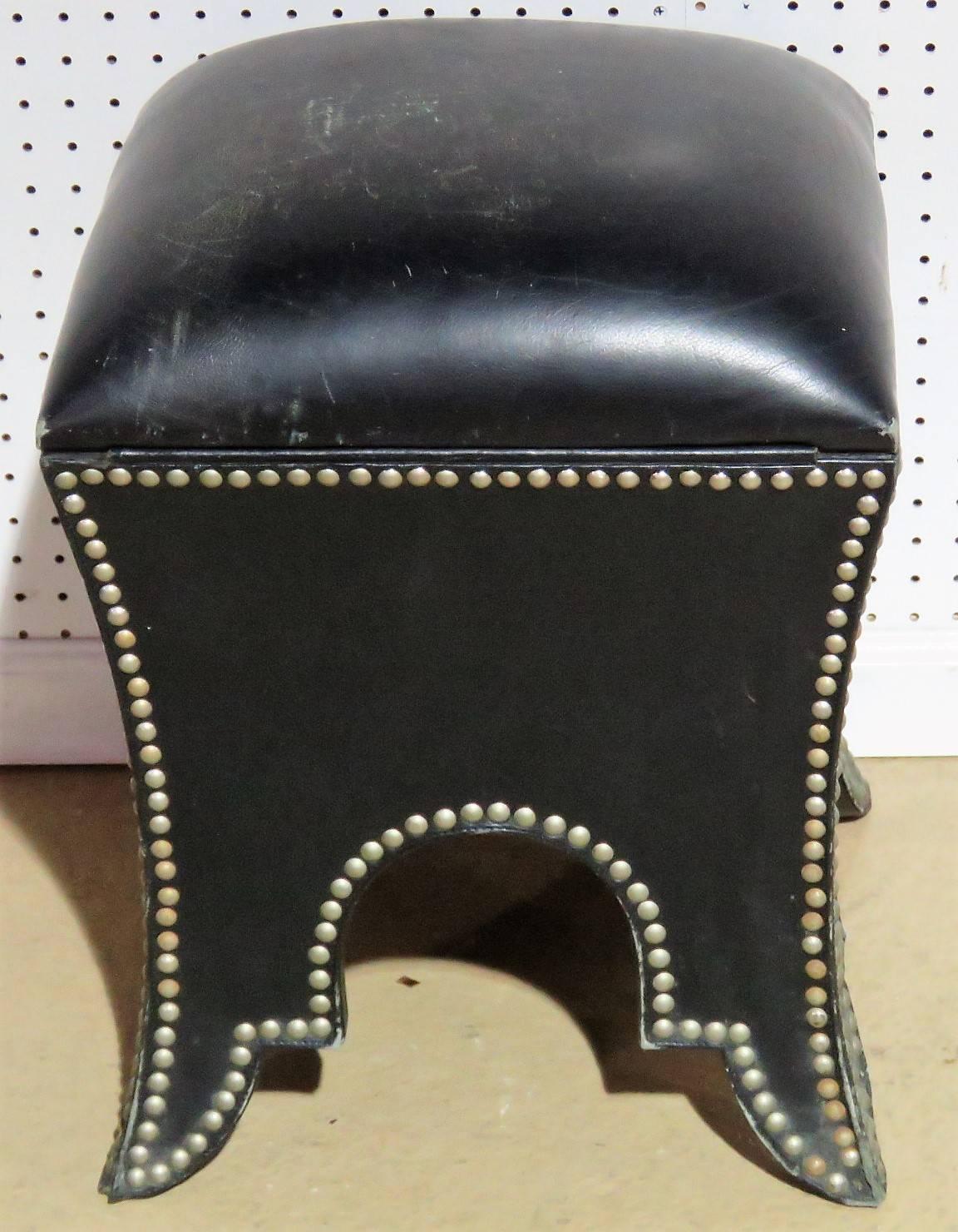 Black leather frame with studded edges. Lift top for storage.