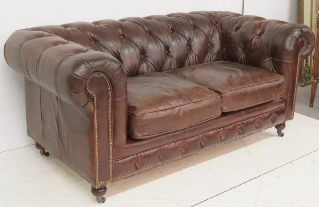 Sofa has a chestnut colored tufted leather.