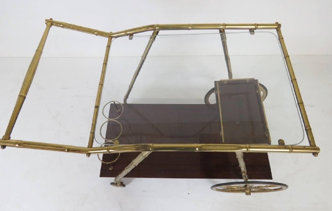 Italian modern brass faux bamboo bar cart. Brass with mahogany shelves.