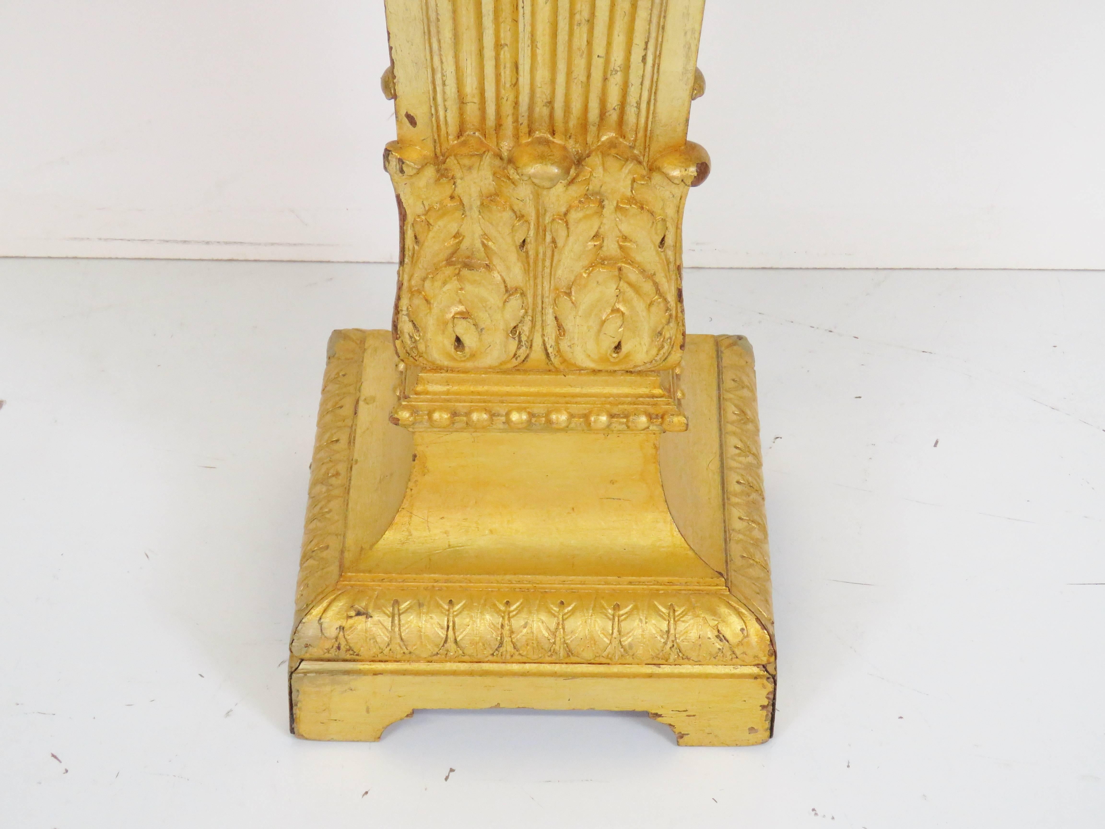 Carved wood with gold gilt pedestal. Measures: 43