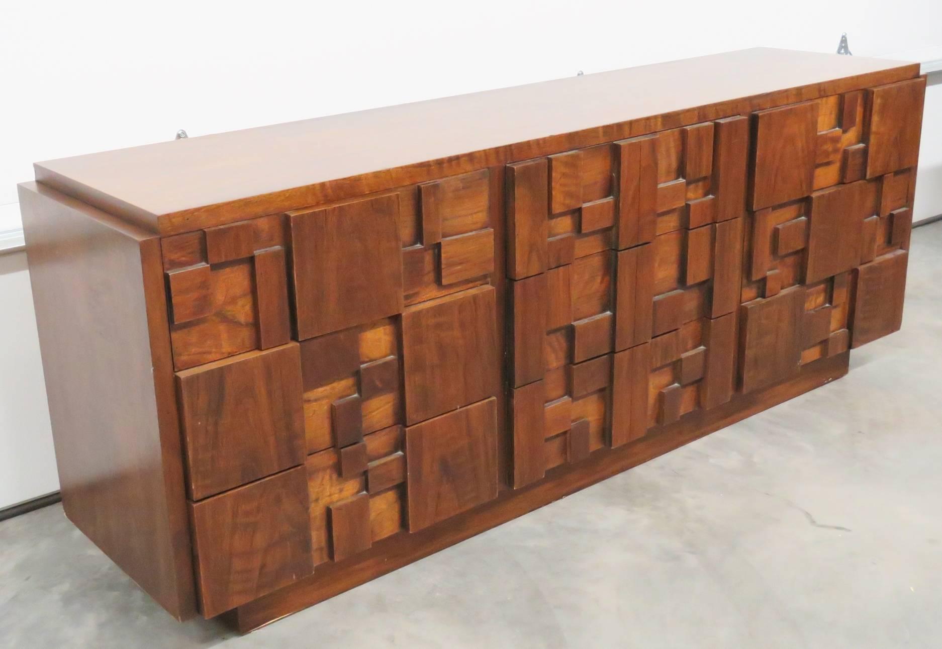 Dresser has a Brutalist style walnut wood nine-drawer dresser with two front panel doors manufactured by Lane Furniture Co from the 