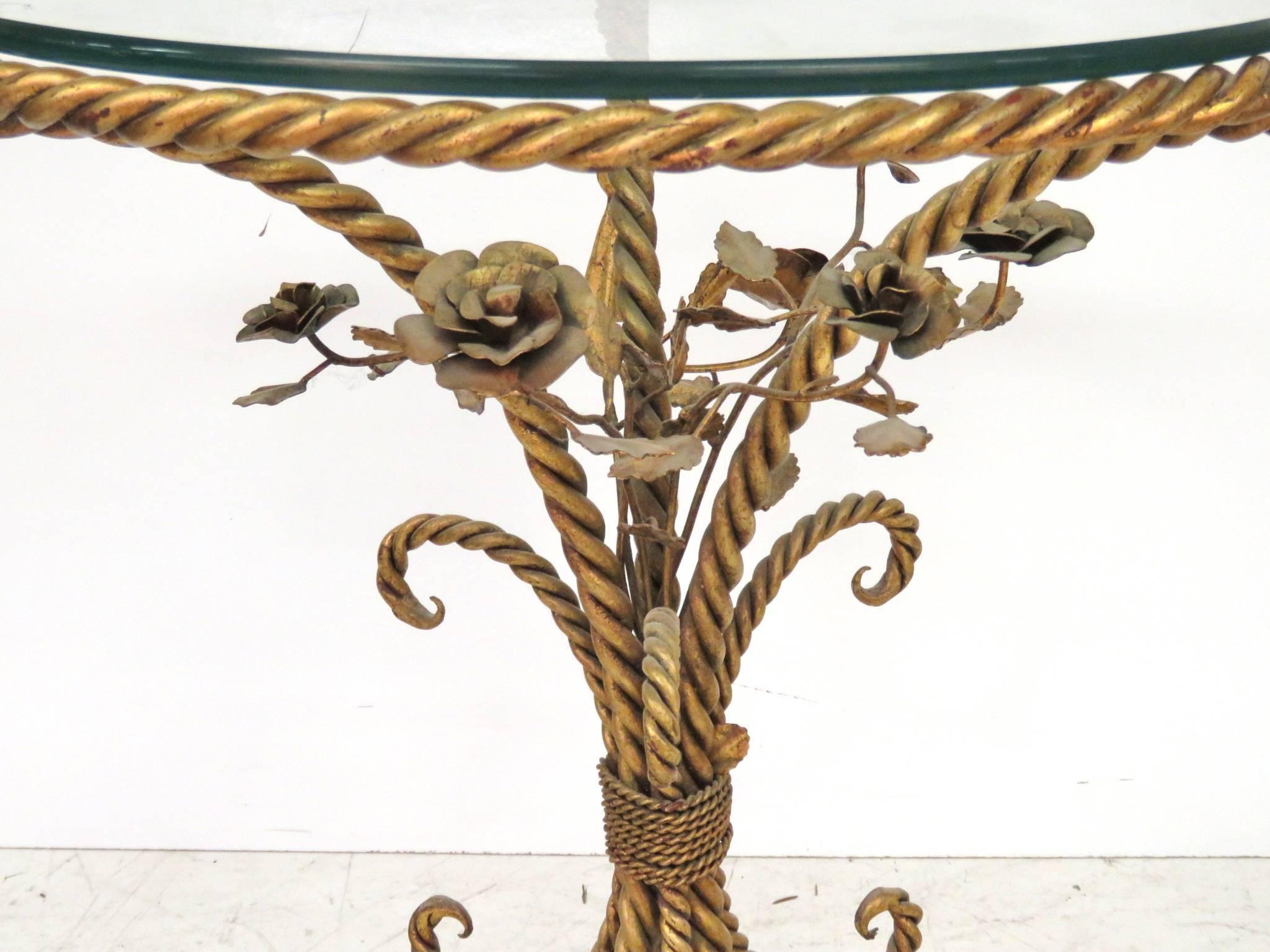 Center table is gilt wrought iron with flowers and a glass top.