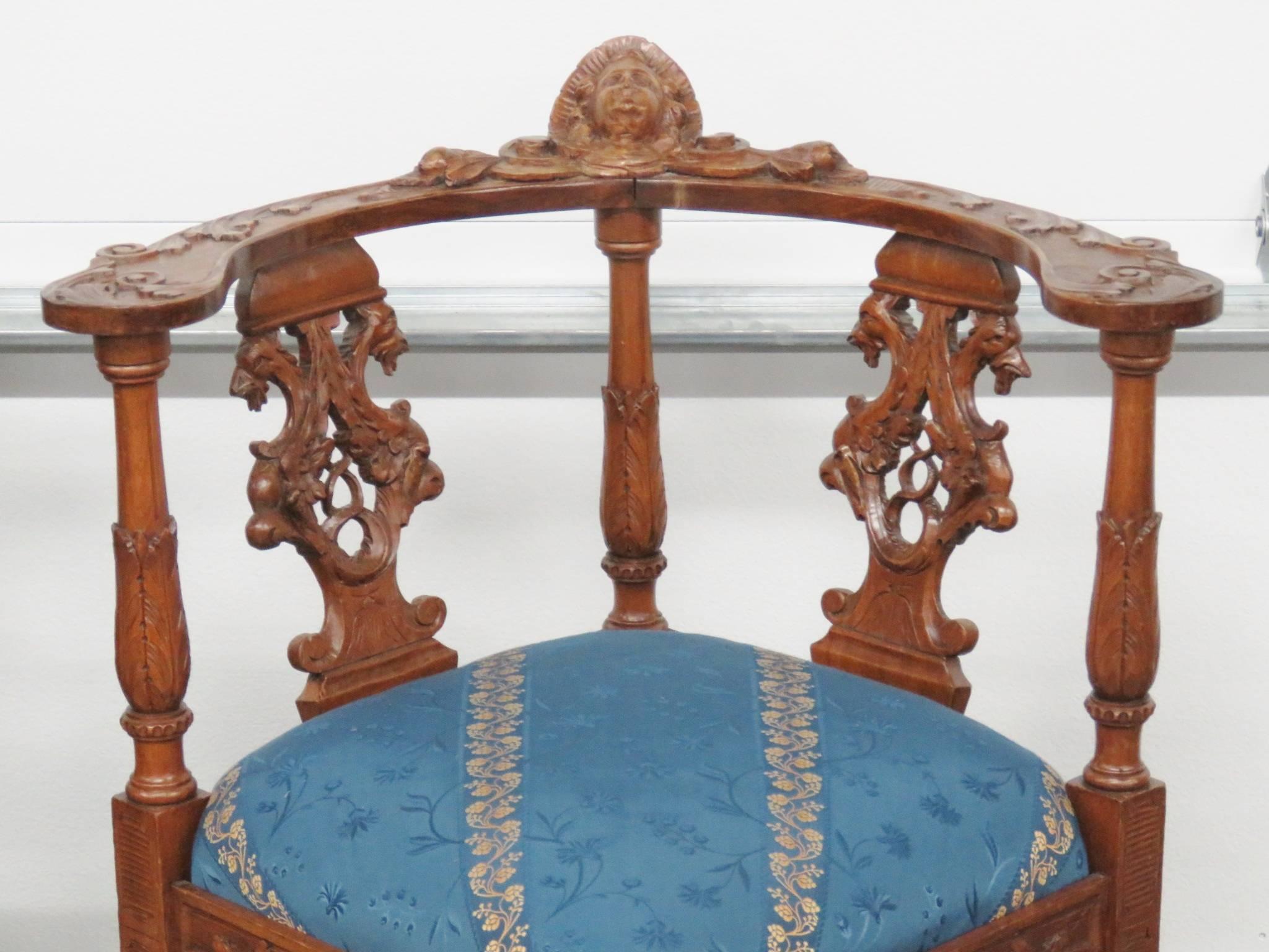 Carved frame with cherubs and upholstered seats.