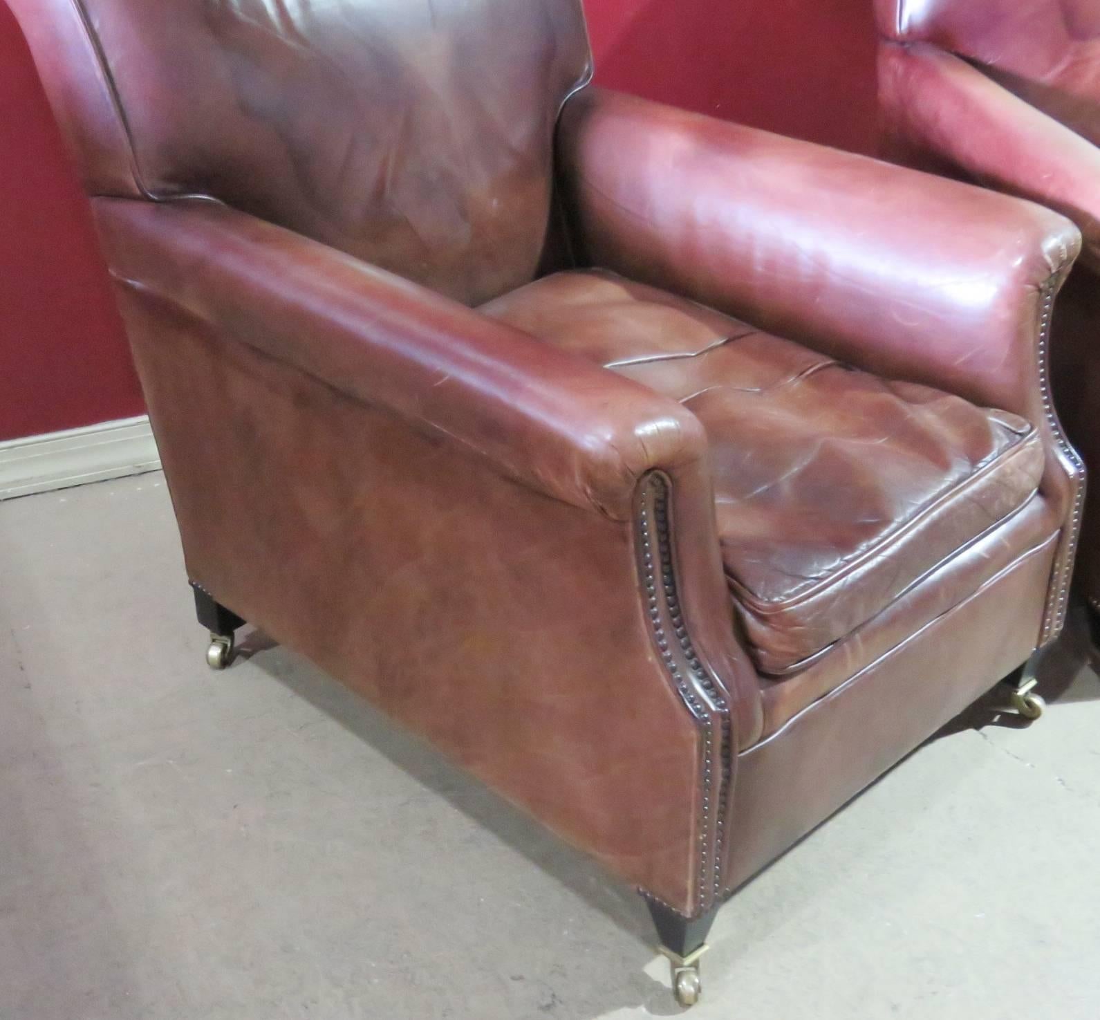 Pair of brown leather club chairs.