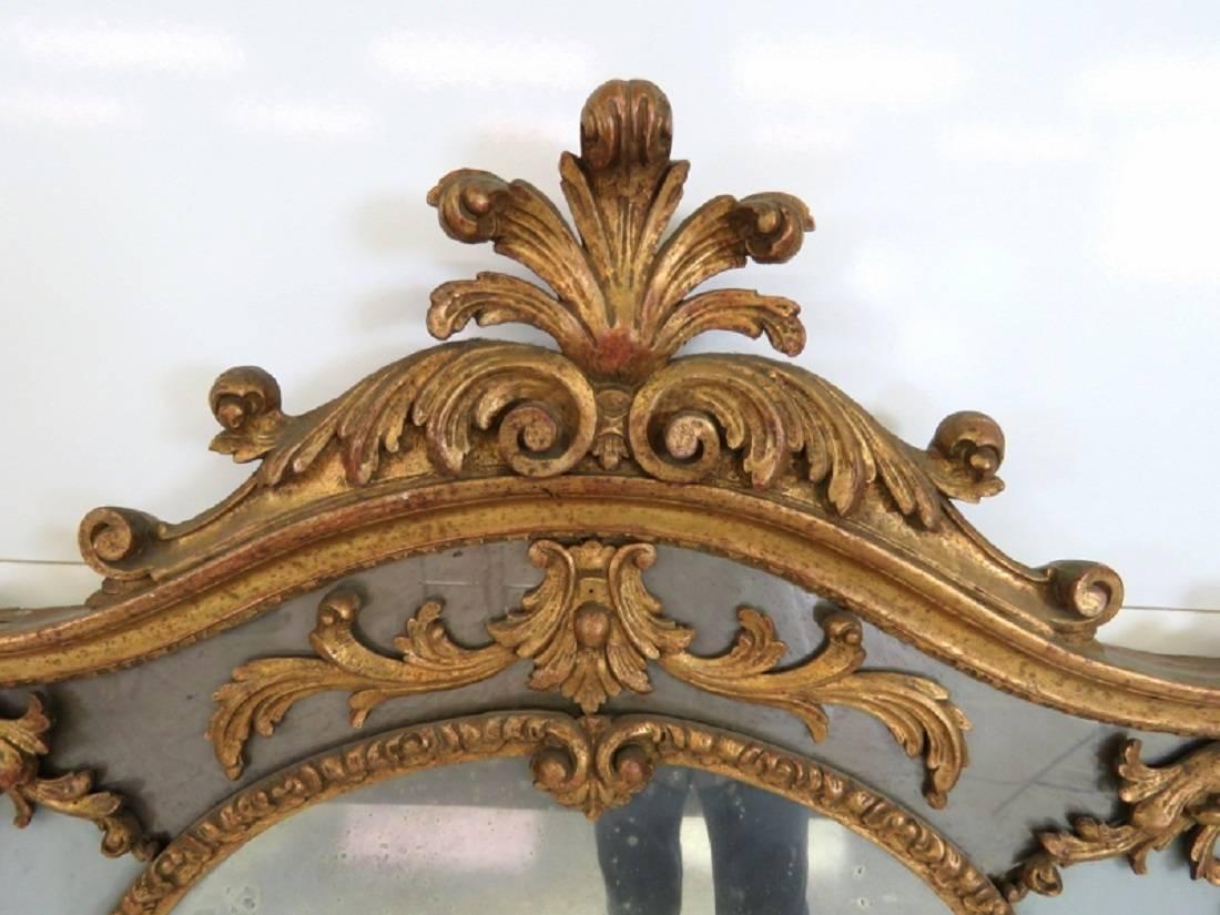 Carved giltwood with distressed silvered mirror.