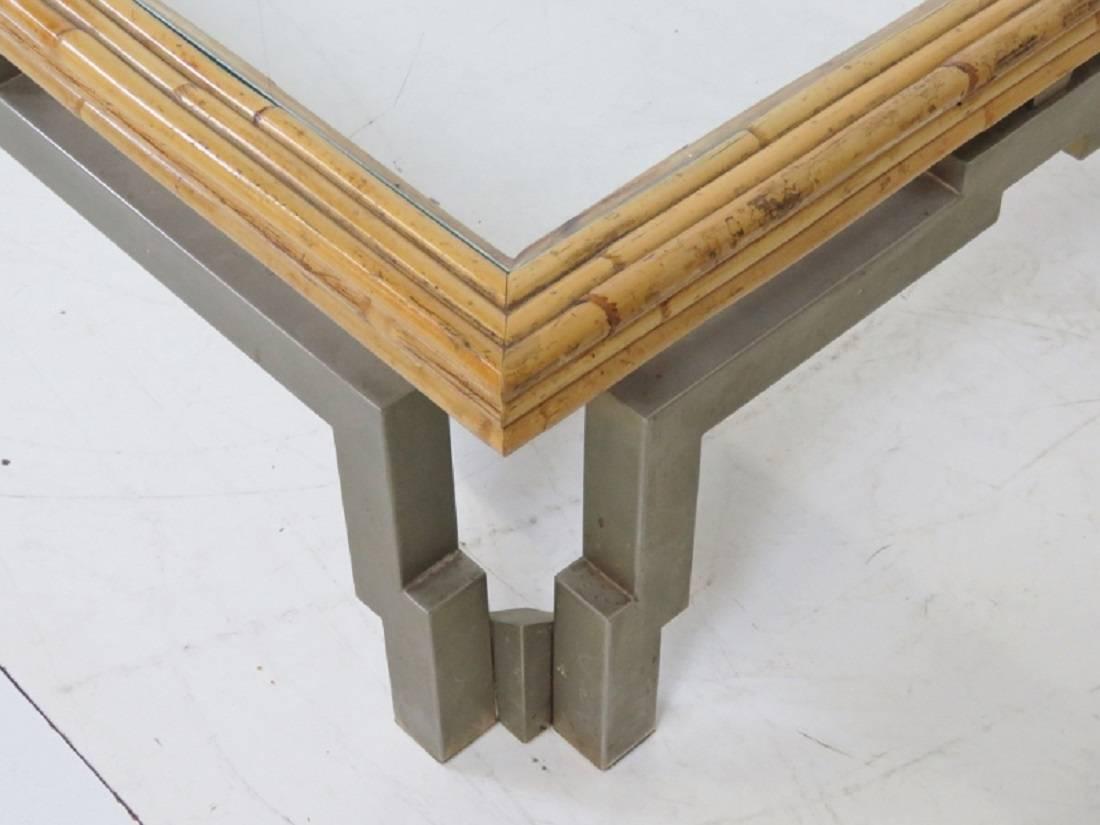 Metal legs with a bamboo framed glass top.