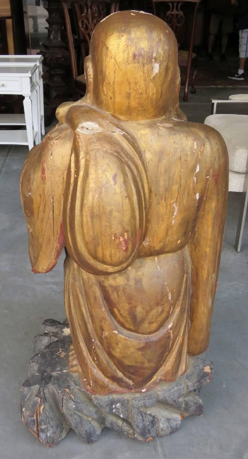 tall wooden buddha