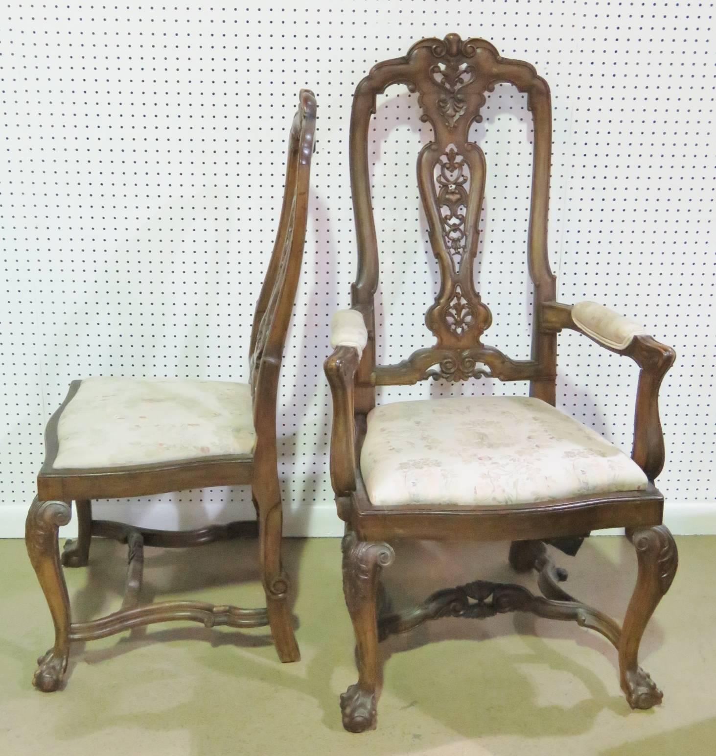 Walnut carved frames with upholstered seats and arms. Set includes two armchairs and six side chairs.