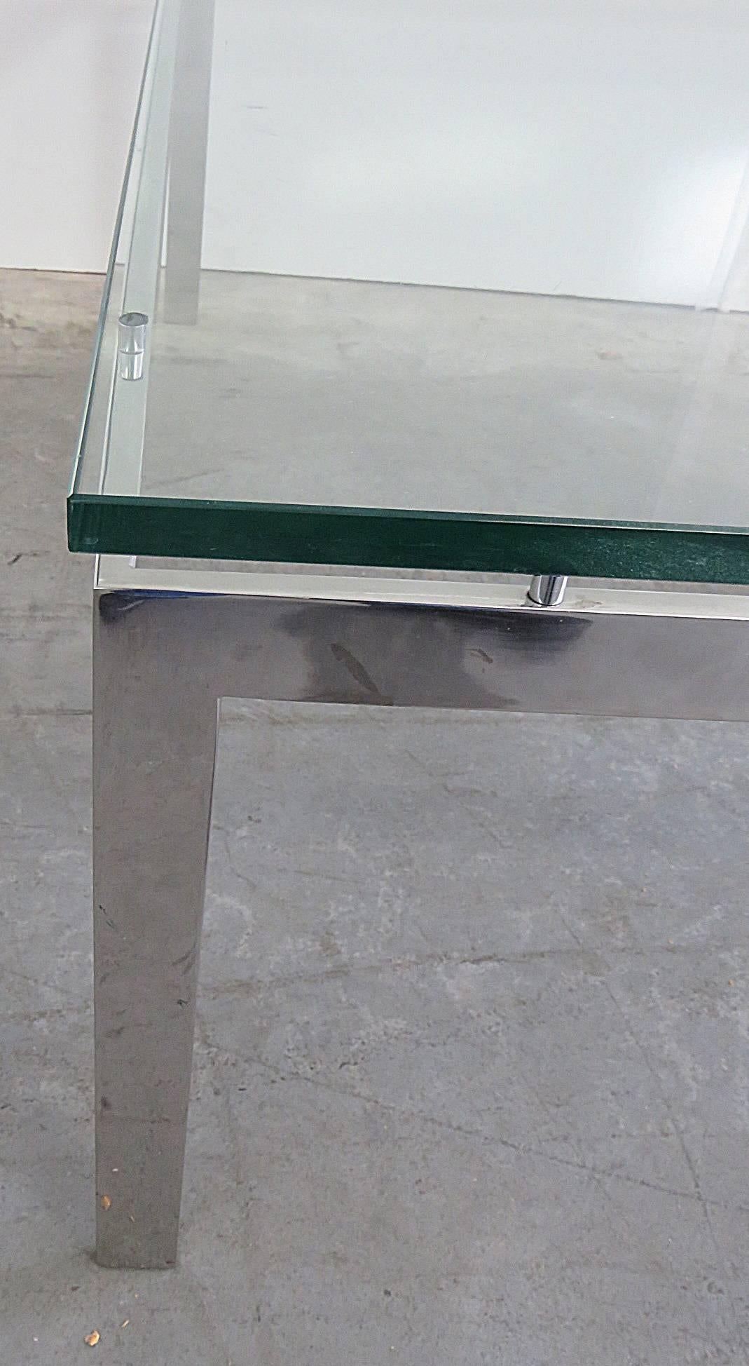 Glass top coffee table with a flat bar stainless steel base attributed to Knoll.