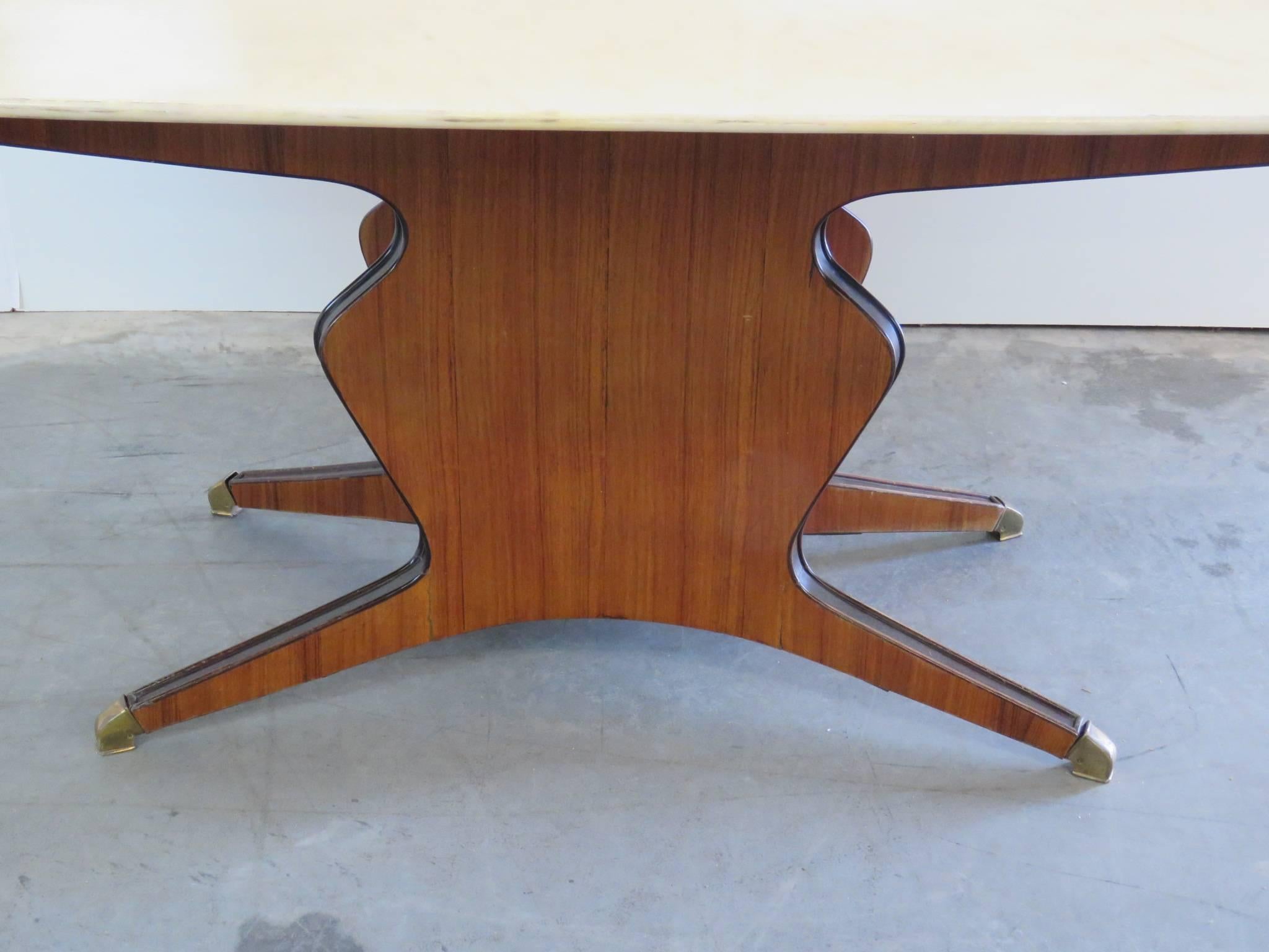 Borsani style marble-top dining room table with brass feet.