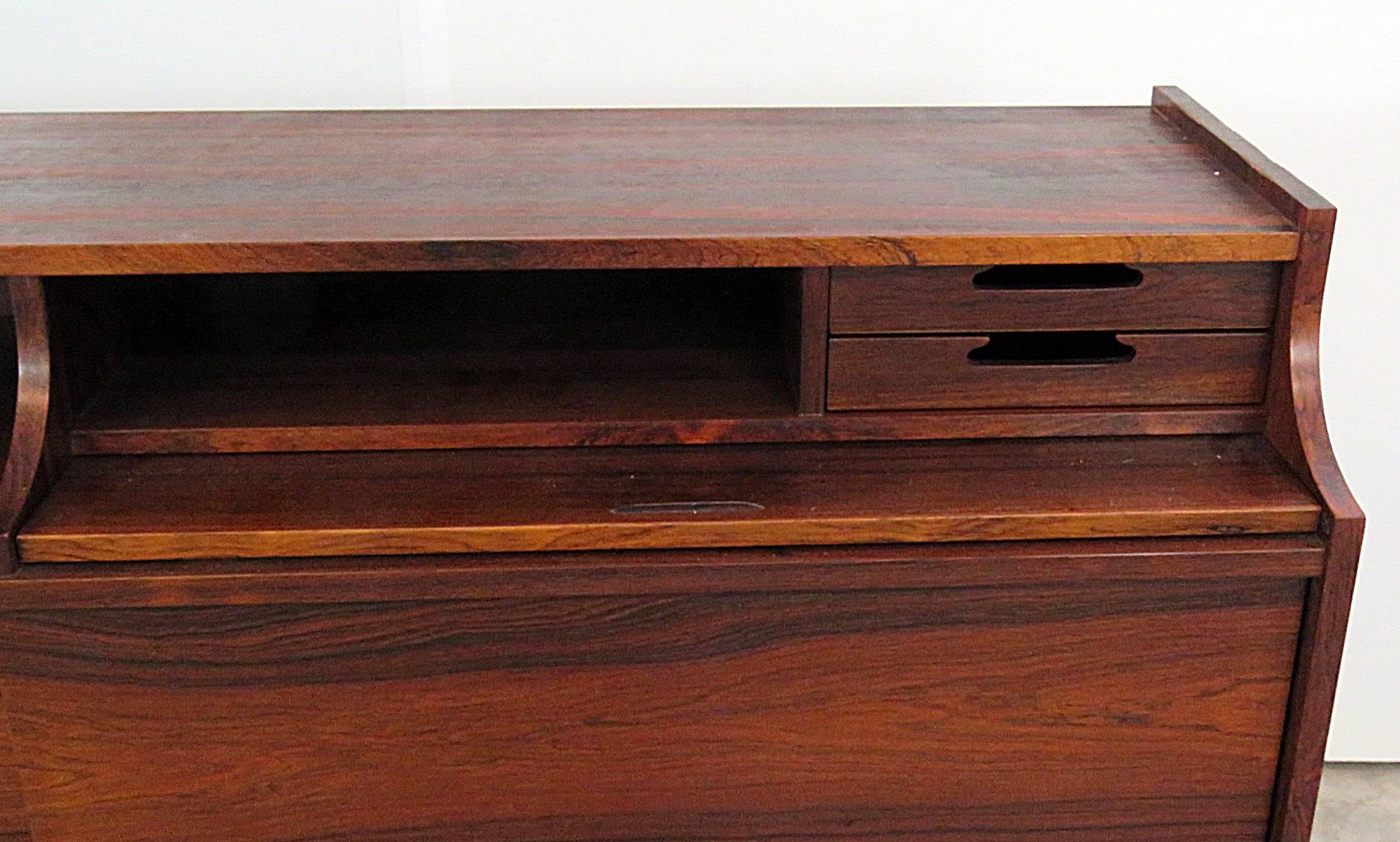 Frattini rosewood sideboard or credenza with two doors each having one shelf, seven drawers and one pull-out desk.