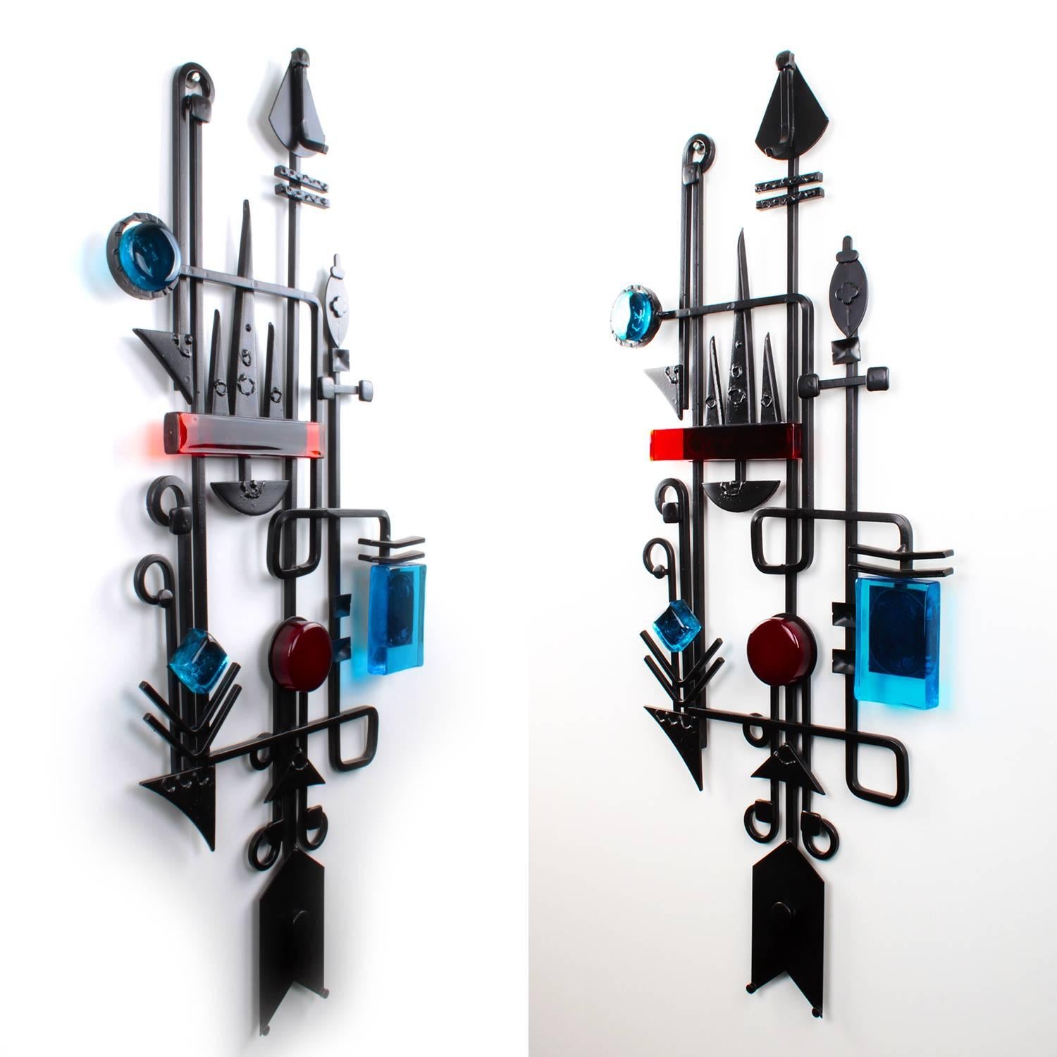 Wall sculpture by Dantoft Kunstartikler, Denmark, circa 1960s. Unique artisan work in wrought iron with glass pieces in clear blue, dark red and orange.

Wondrous collage of imagination and geometric shapes-materialized in black, welded wrought