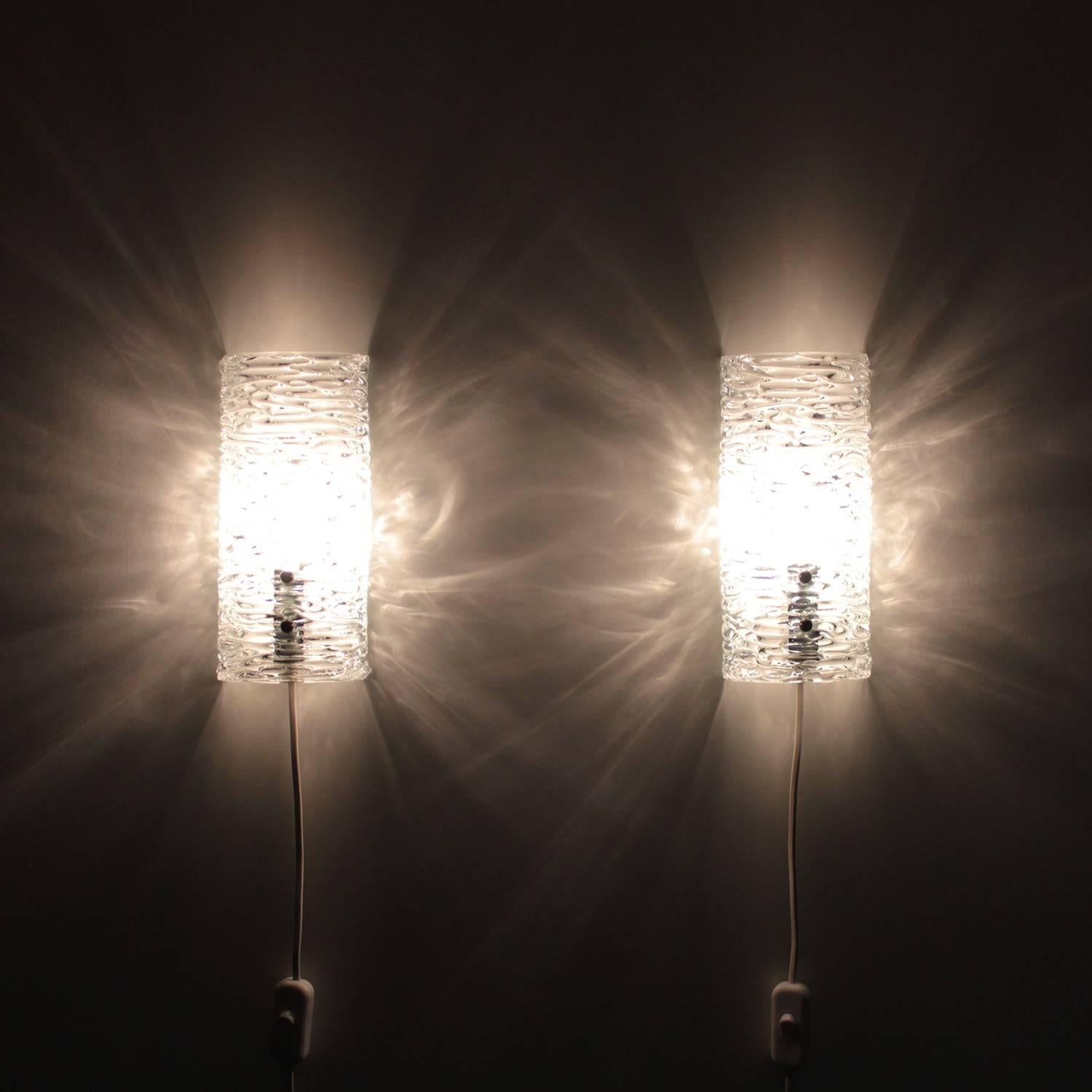 Crystal sconces (pair) - pair of clear crystal glass wall lights by unknown producer, 1960s. Beautiful Scandinavian Modern crystal glass wall lamps and in excellent vintage condition.

Each of these beautiful sconces are comprised of a clear