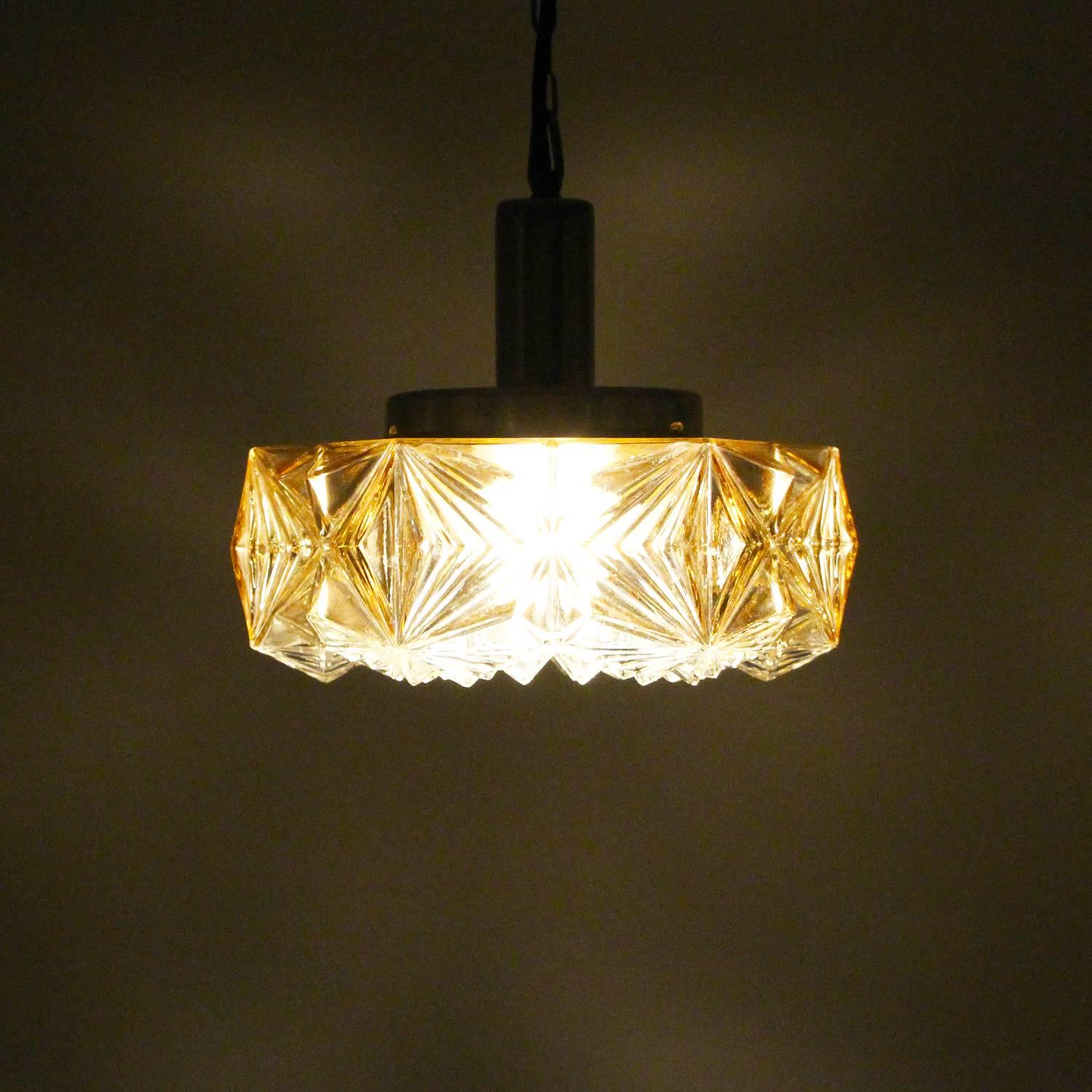 Pressed glass pendant, no. 36404 by Vitrika in the 1960s, vintage pressed glass hanging light with brass top, chain and canopy, all in very good vintage condition.

Up for sale here is a charming midcentury piece, made up by a thick pressed glass