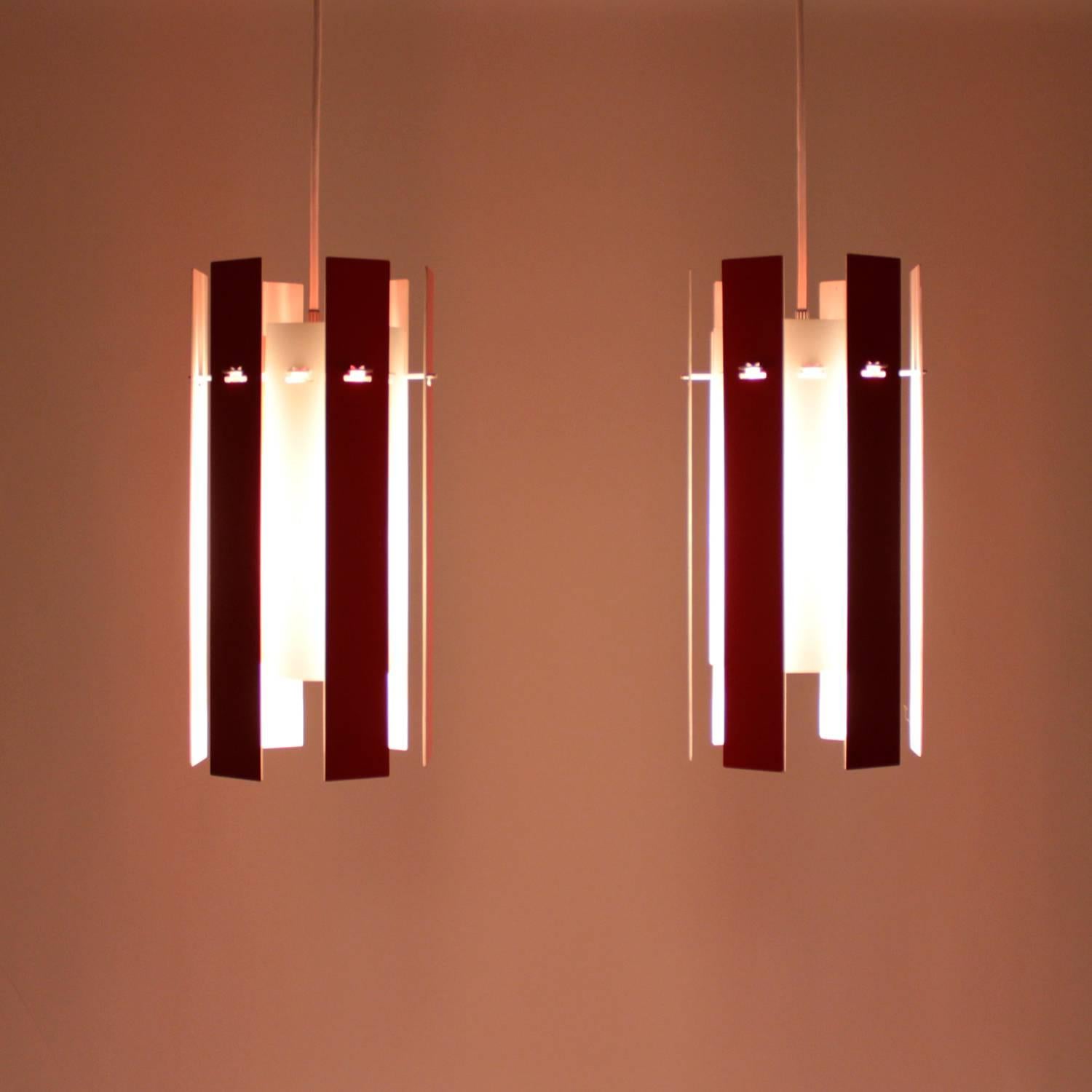 Cocktail pendant pair by Henning Rehhof in 1971 and produced by Fog & Mørup - Rare and very attractive pair of red and white hanging lamps!

The spectacular Cocktail is made up of 12 detachable aluminum strips in two different lengths. Painted red
