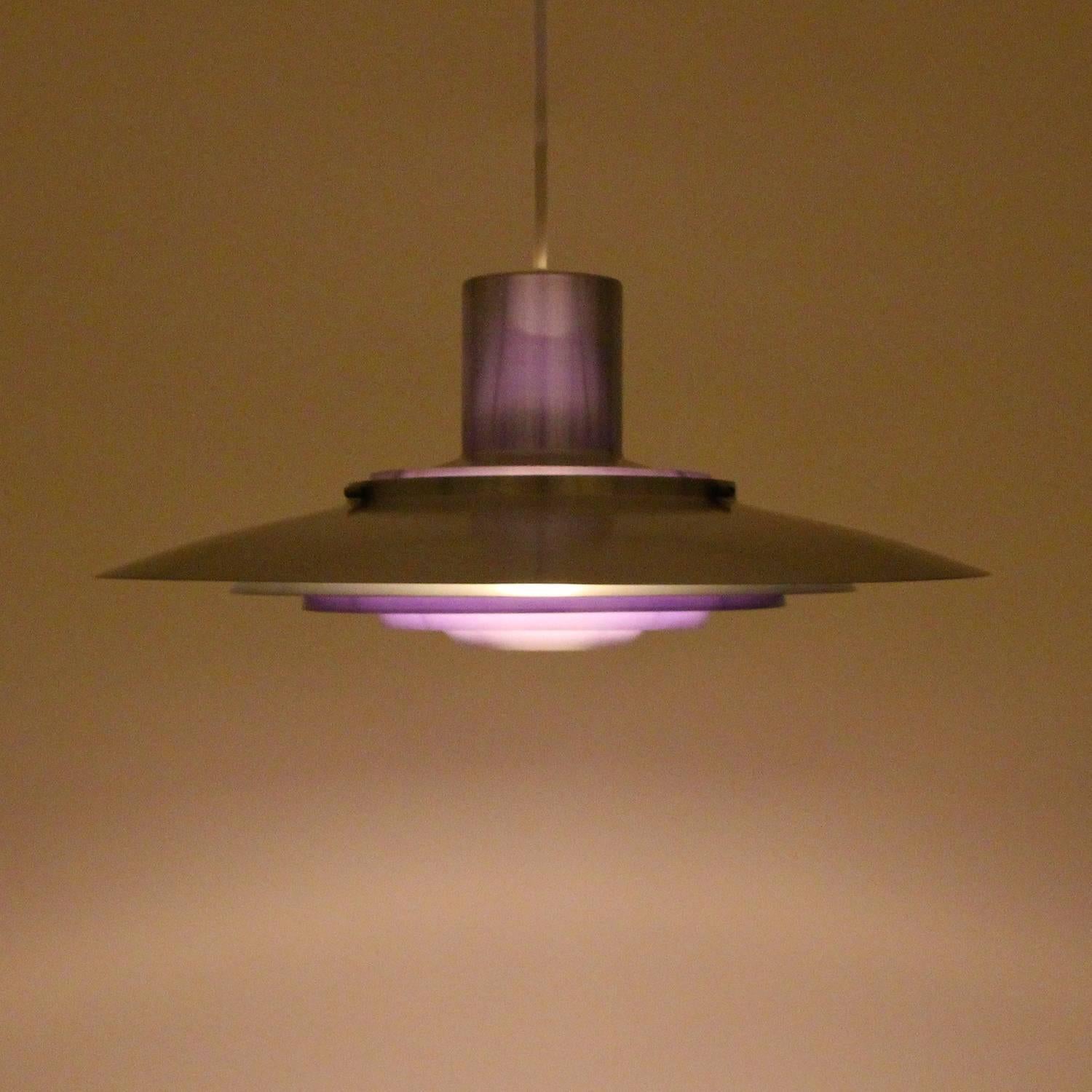 Kastholm pendant by Fabricius & Kastholm for Nordisk Solar Compagni in 1964 - large timeless aluminum and purple hanging light in excellent vintage condition.

A gorgeous piece comprised of five ring-shaped aluminum shades with purple inner