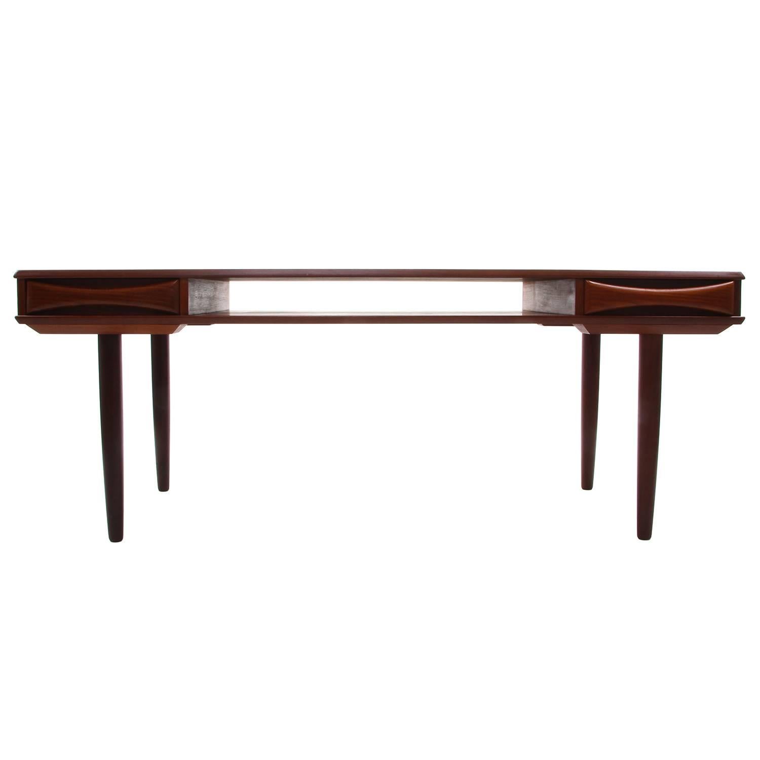 Teak coffee table by Danish furniture maker in the 1960s - beautiful Scandinavian Modern teak coffee table with shelf and two drawers, in very good vintage condition.

A gorgeous midcentury piece, crafted in teak, rich in color and proudly showing