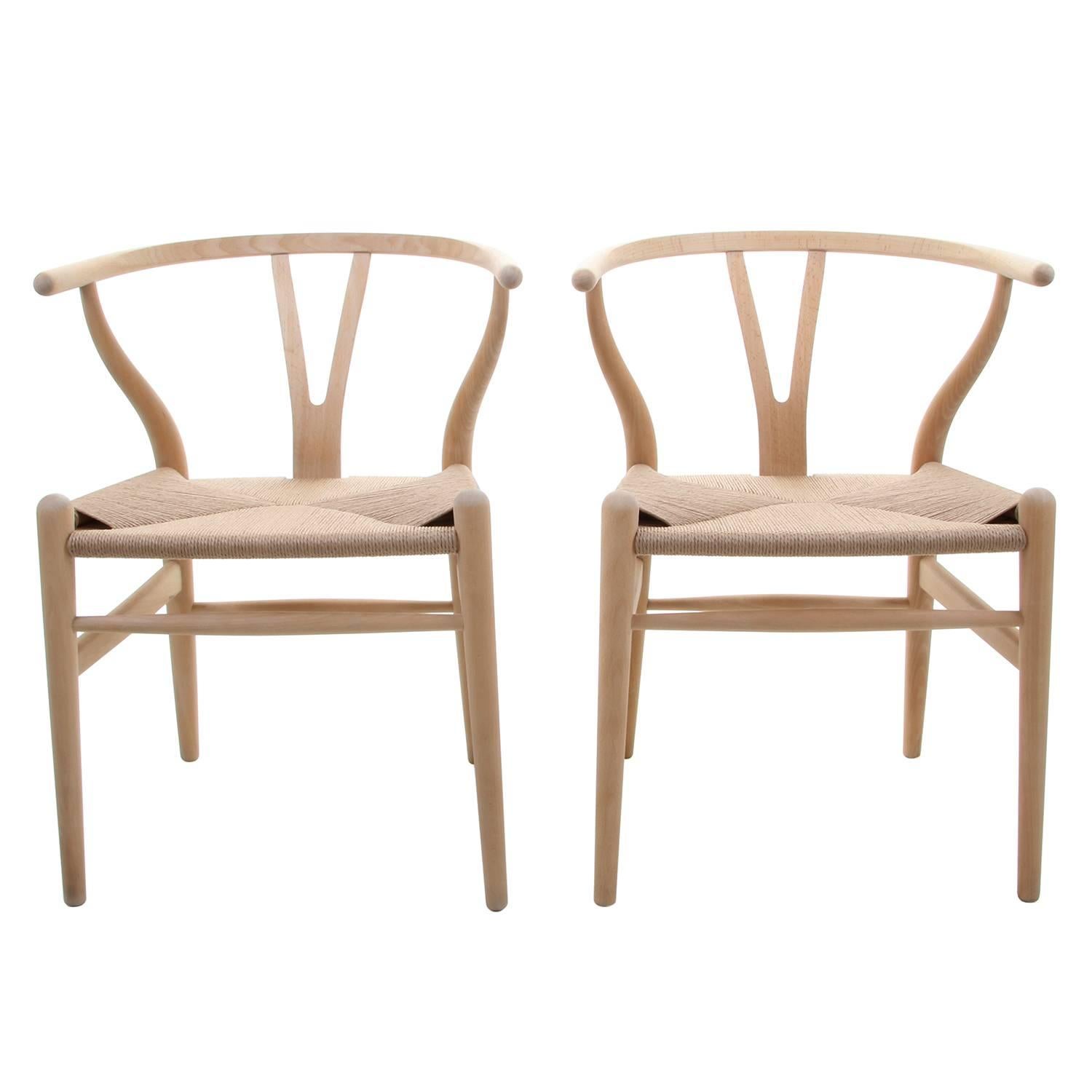 CH24 - wishbone chairs by Hans J Wegner for Carl Hansen & Søn in 1949 - iconic Danish design - two beech Y-chairs, soap-treated and fitted with new woven paper cord seats. In excellent vintage condition!

The CH24 or wishbone chair is by far the